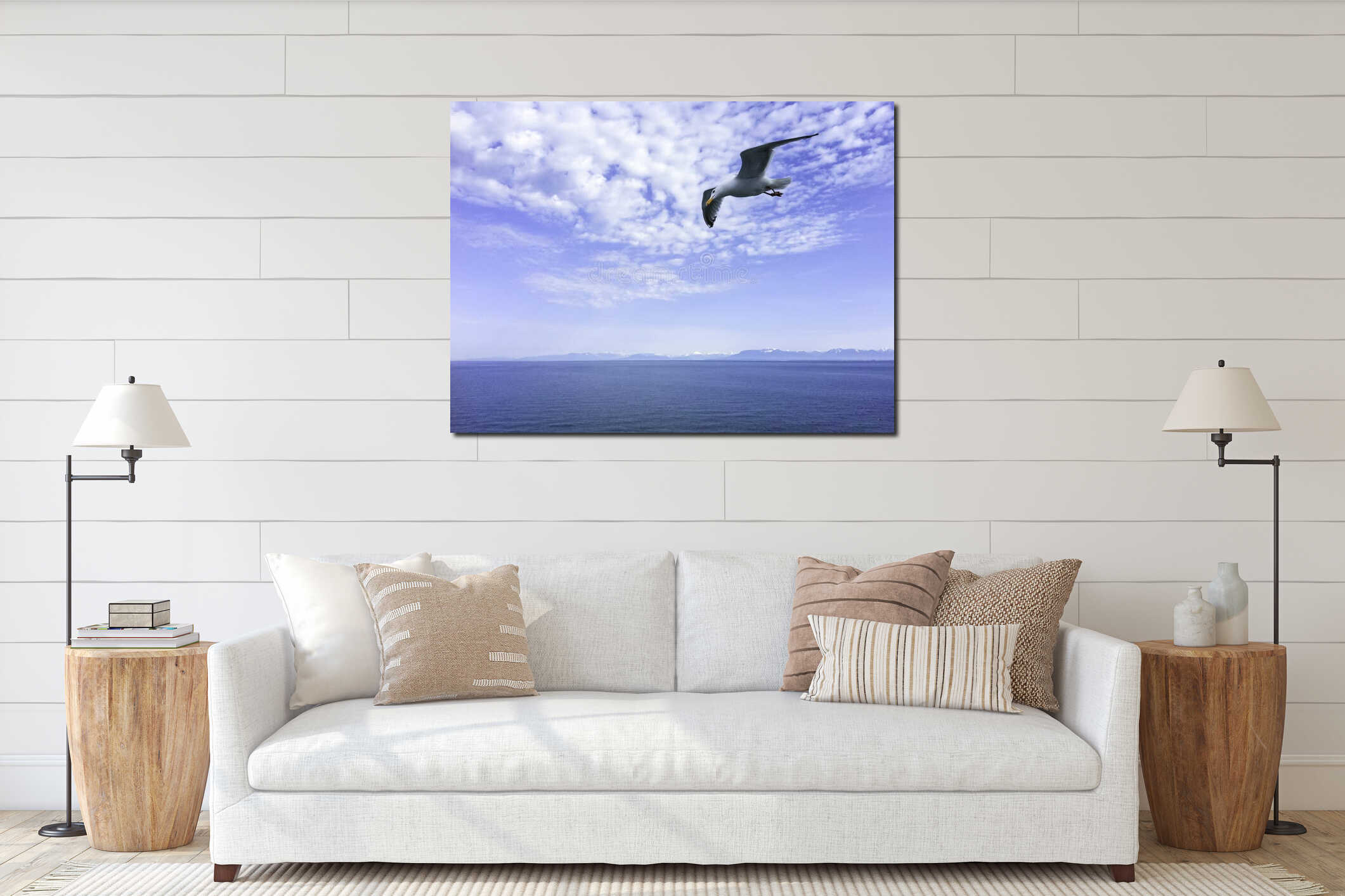 Cute seagull animal yellow sharp mouth flying  spread two wings over water sea on blue sky. beauty white fluffy clouds in sunny da interior mockup