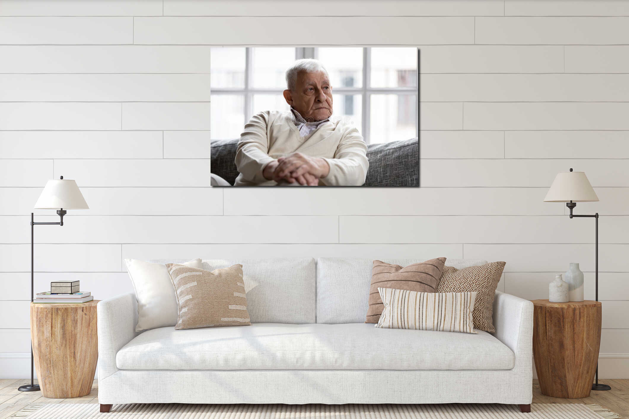 Pensive old man sitting on couch in living room alone interior mockup