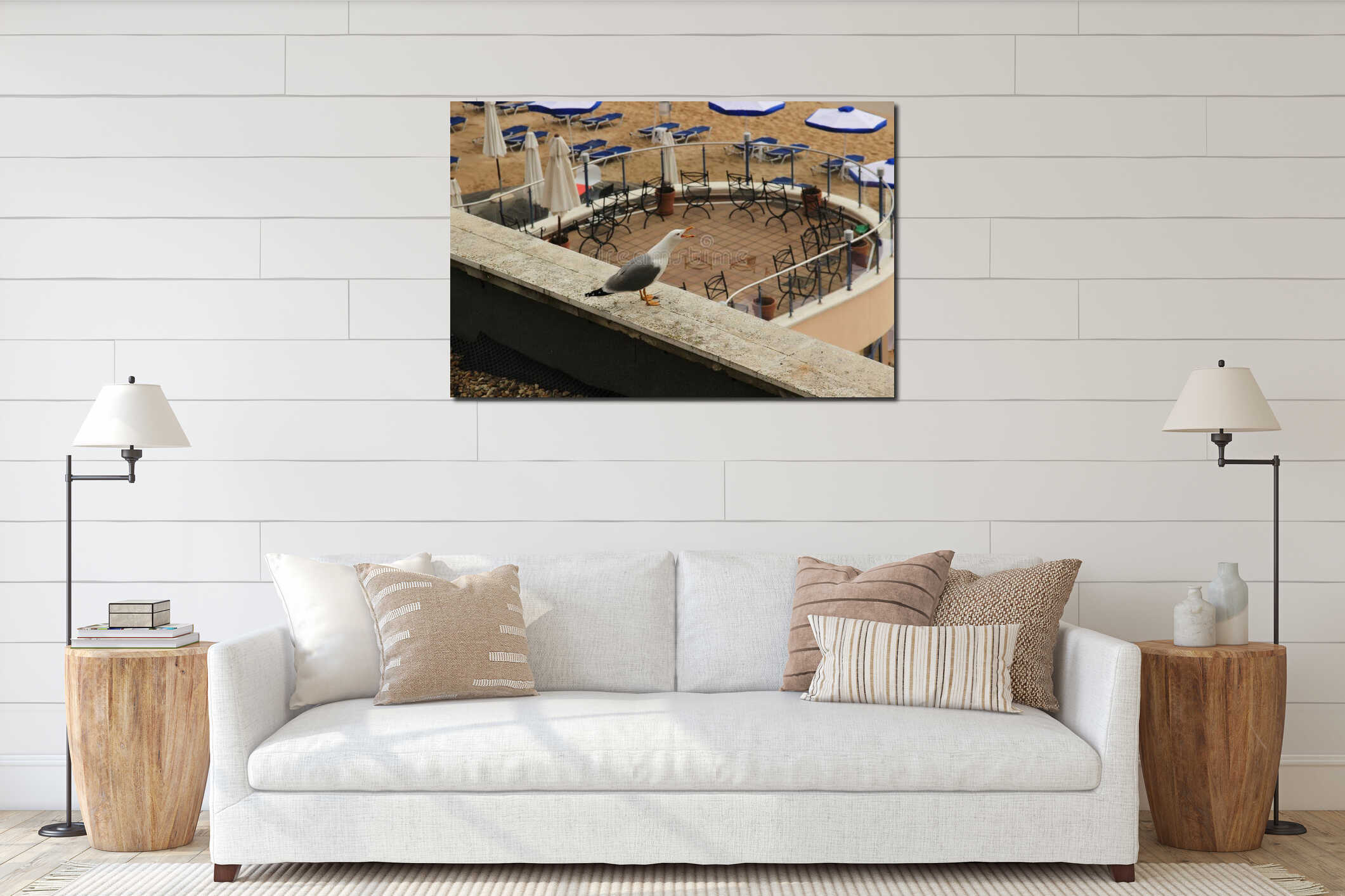 Seagull sitting on the parapet of the balcony overlooking the veranda interior mockup