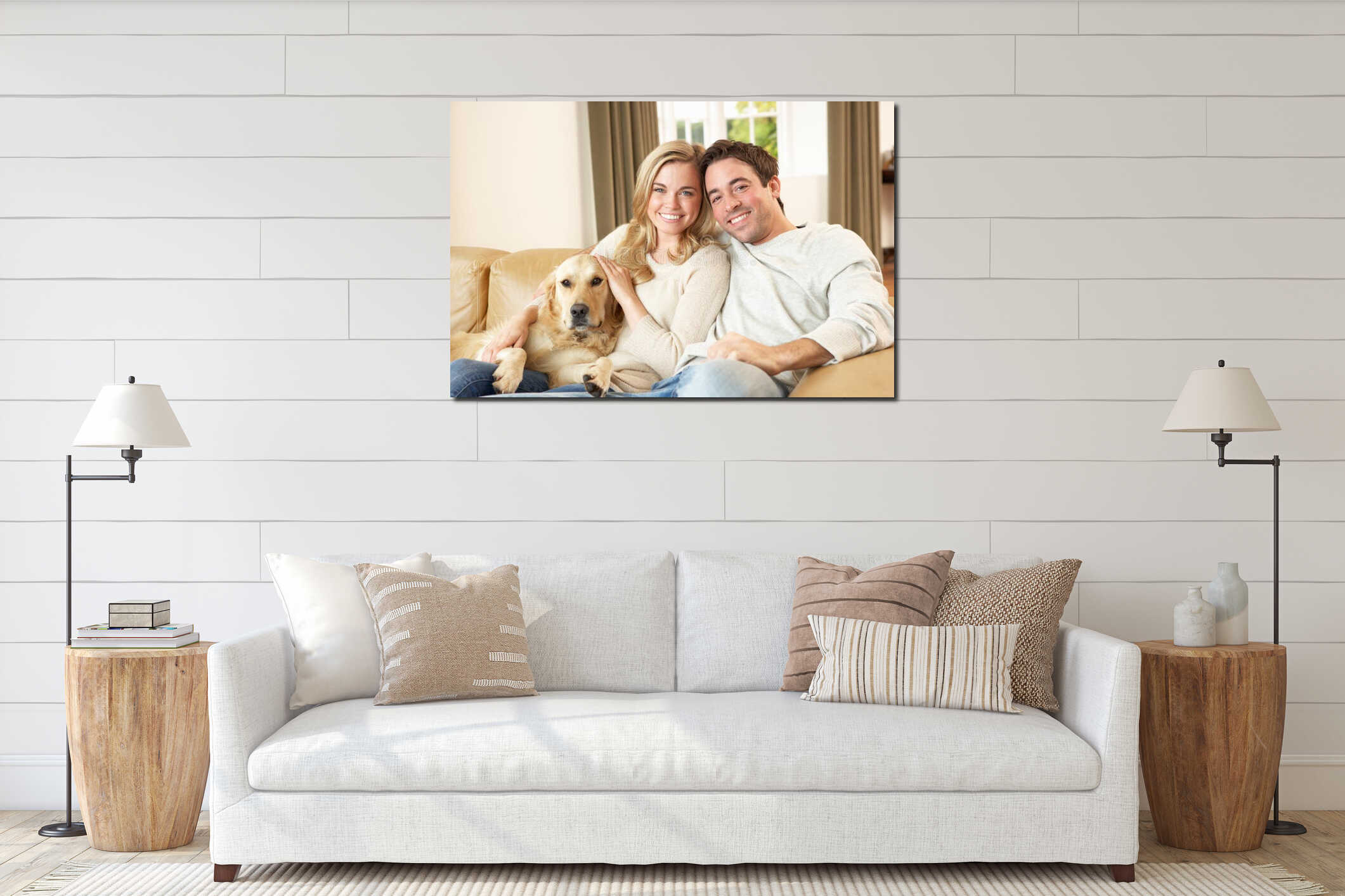 Young happy couple with dog sitting on sofa interior mockup