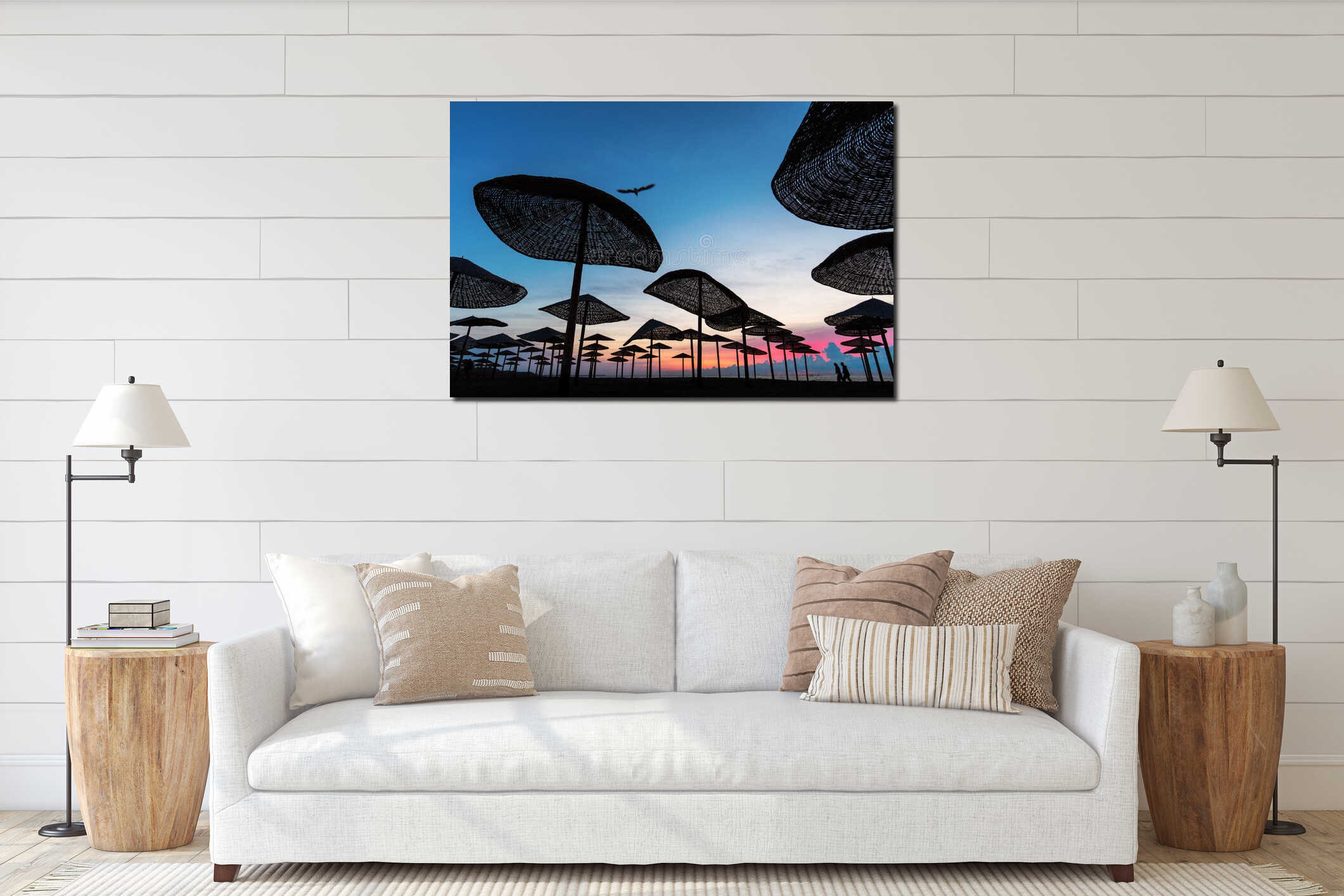 Couple walking on the beach at sunrise with cromatic umbrella and beautiful colors in background interior mockup