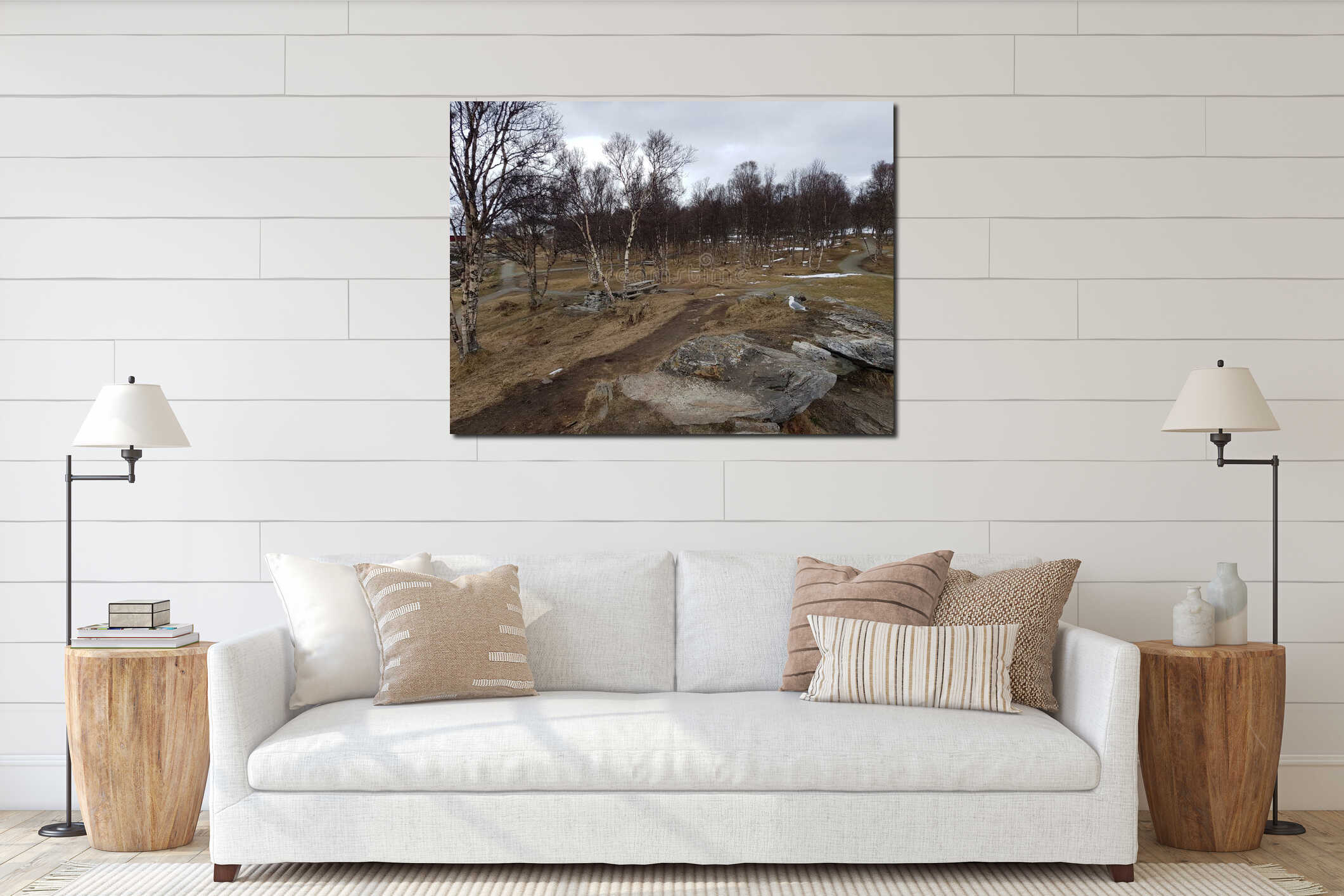 Small seagull standing on small rock top with barren forest background in beginning of spring in the arctic circle interior mockup