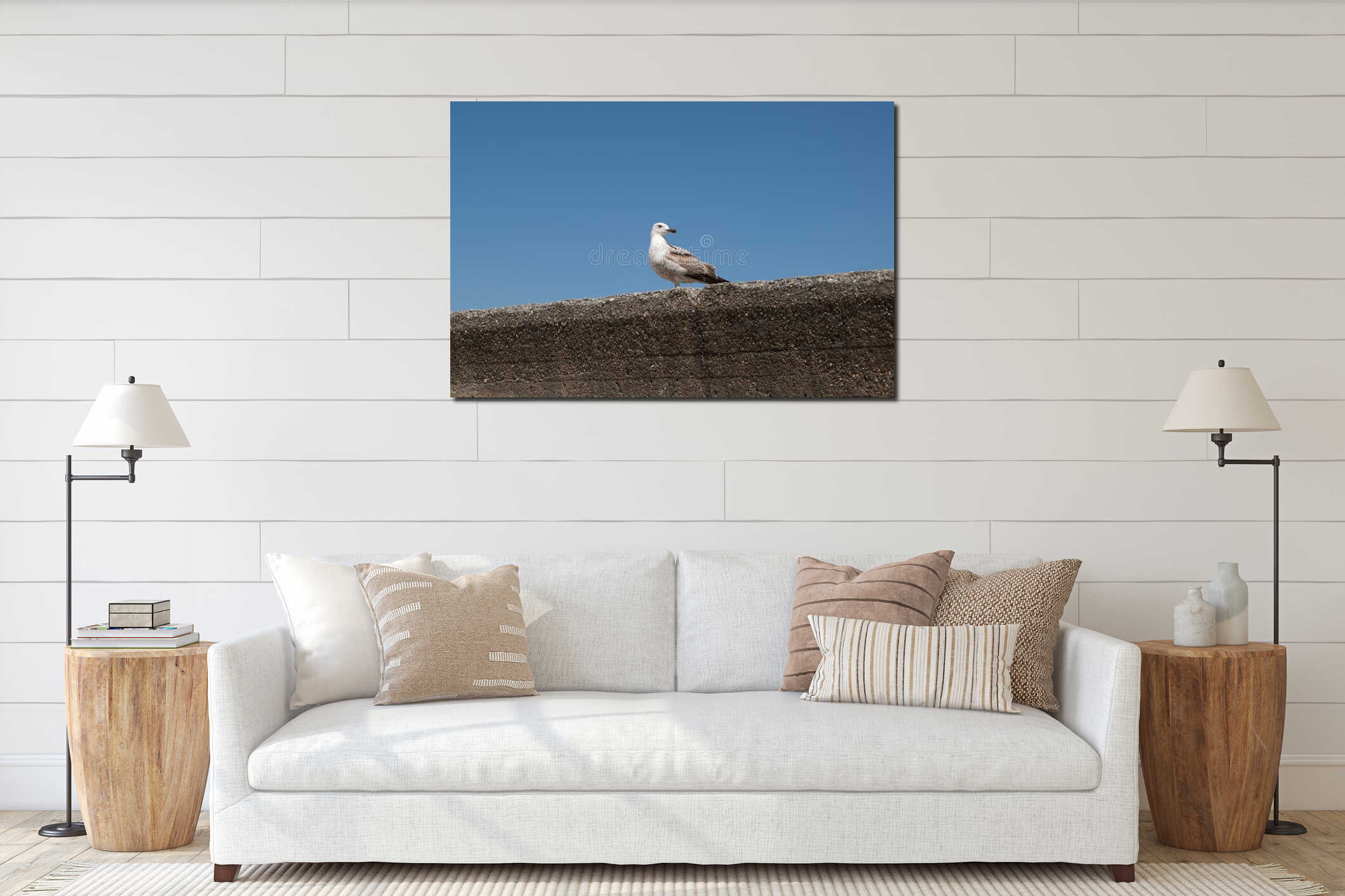 Seagull perched on concrete wall against blue sky interior mockup