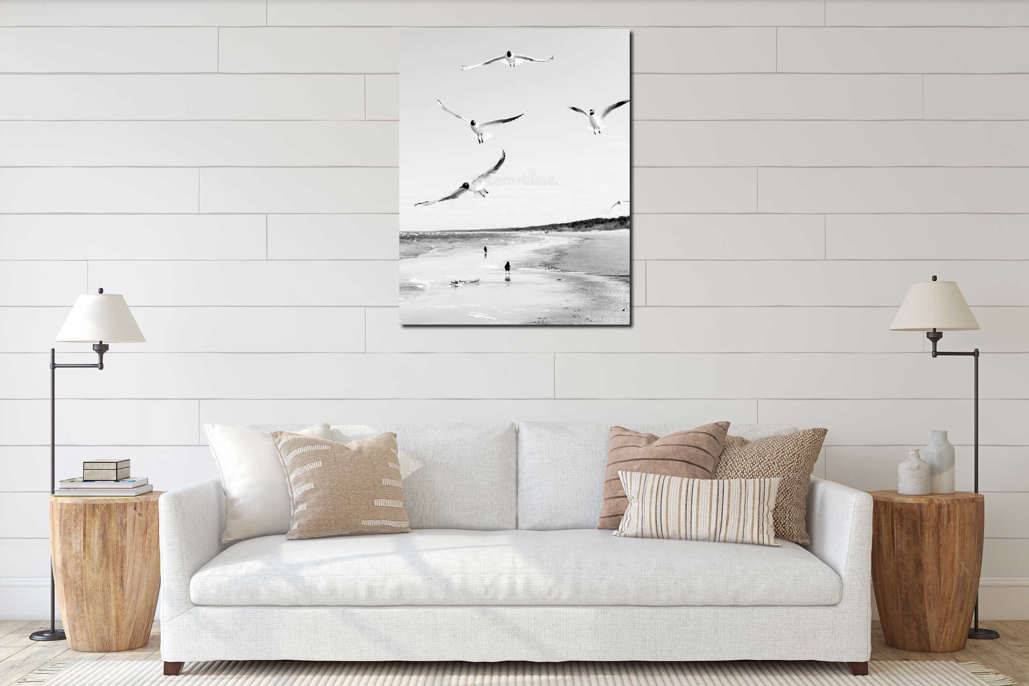 Flock of seagulls flying above the water, with a black crow standing at the background, black and white interior mockup