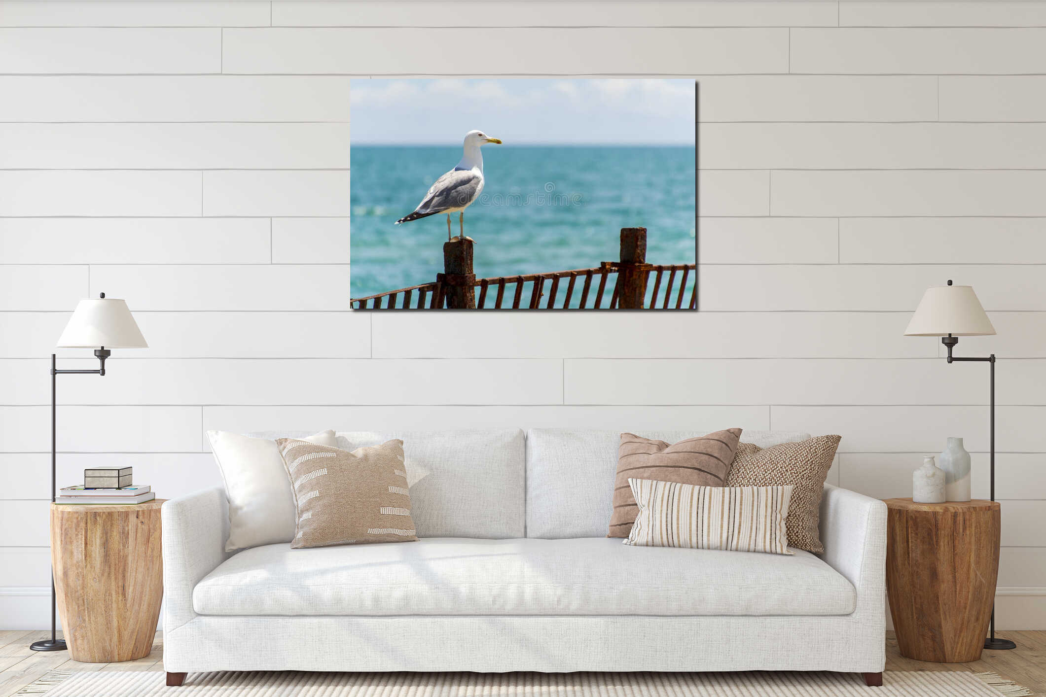The seagull sits on a iron fence. Wings of a bird. Sea bird. interior mockup