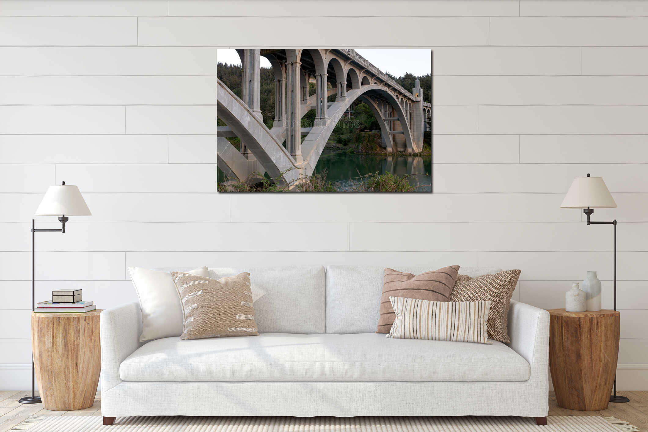 Pilings and arches of the Rogue River bridge in Gold Beach, Oregon at sunset reflected in water interior mockup