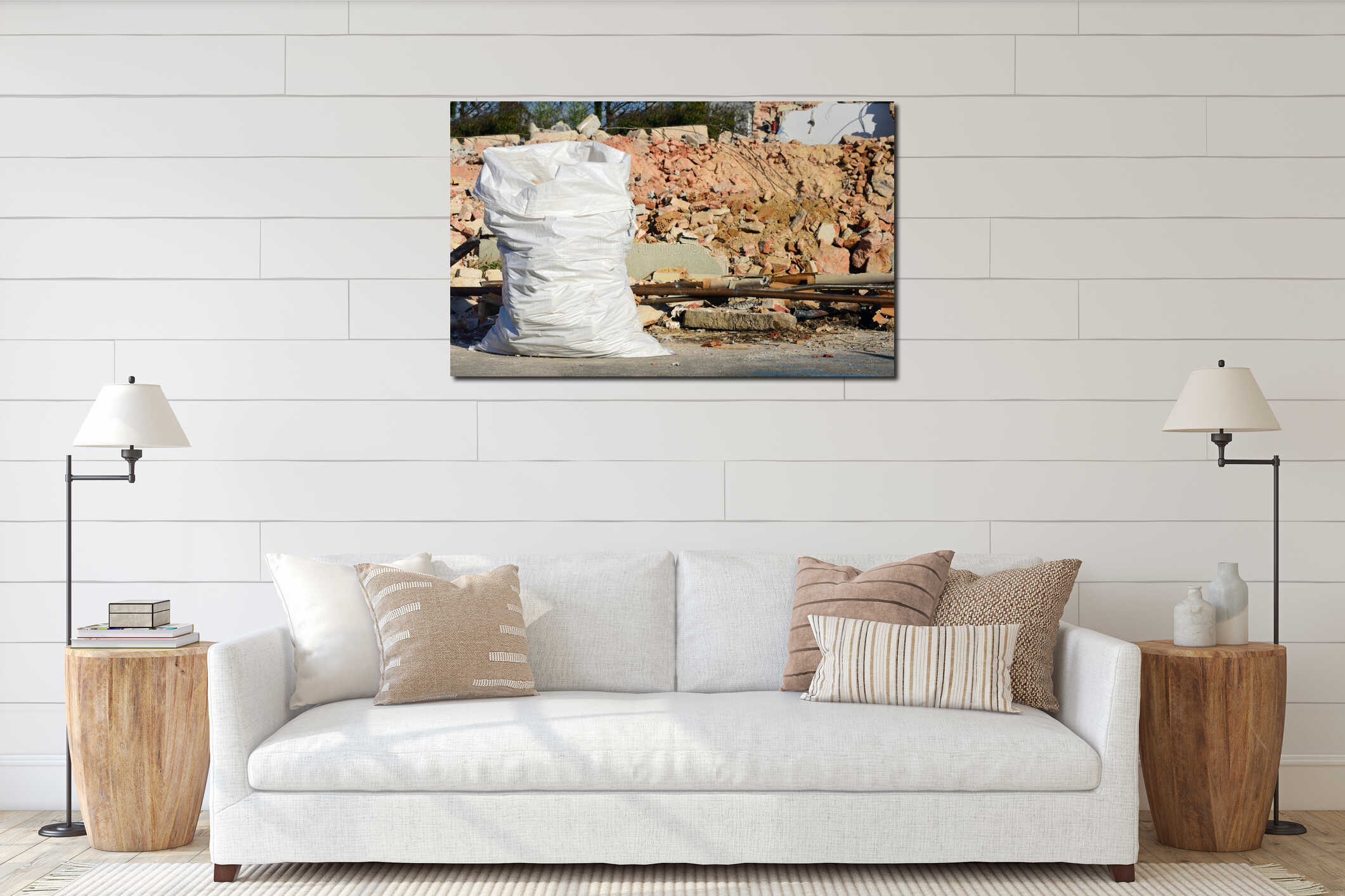 A large white plastic sack full of rubble stands in front of a demolished house with red bricks in the background interior mockup