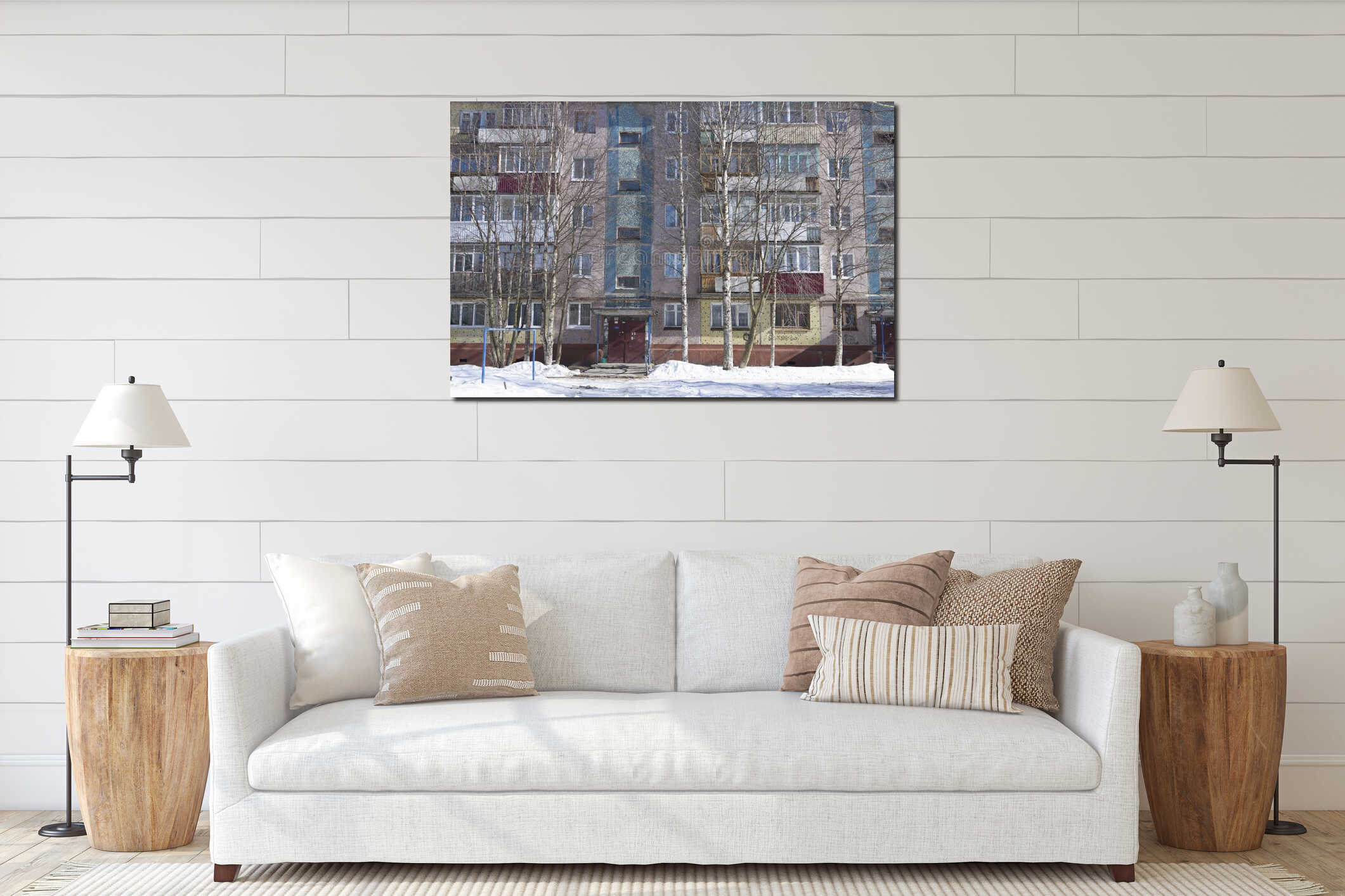 Filled frame full screen shot of an old ugly colorful facade of a soviet block house with windows, balconies and naked birches and interior mockup