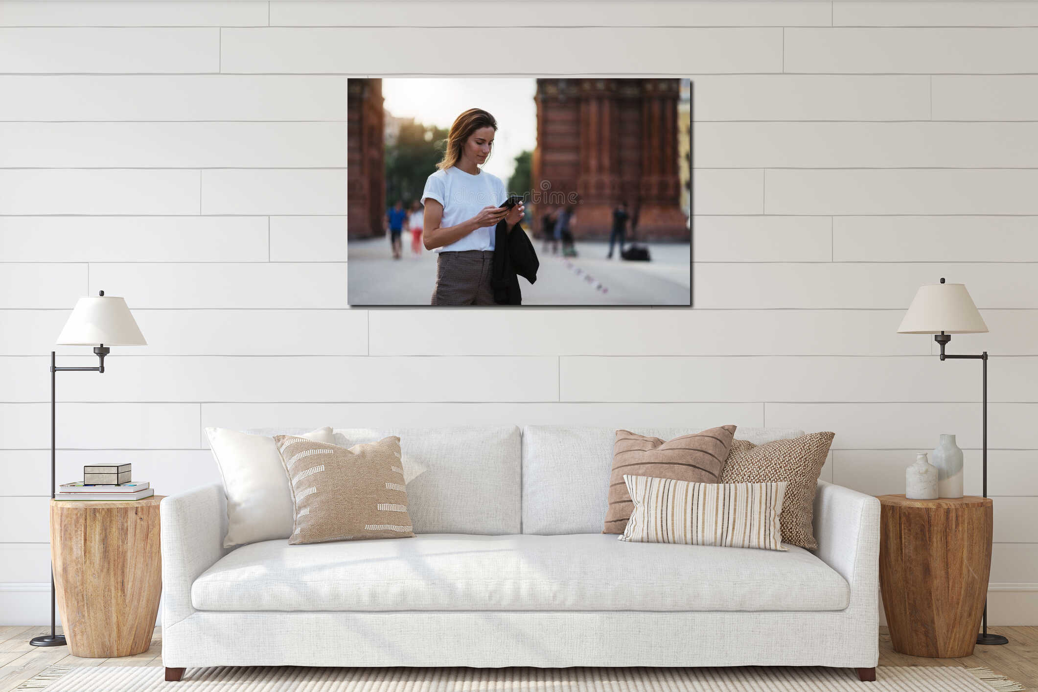 Portrait traveler woman in white t-shirt writes message on smart phone walking arc de Triomphe of Barcelona, tourist girl interior mockup