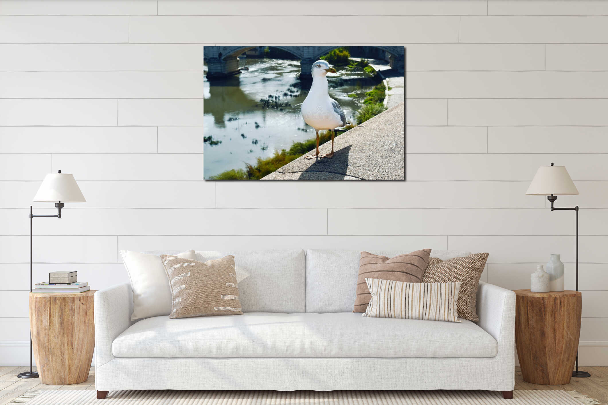 Seagull standing on wall against river interior mockup