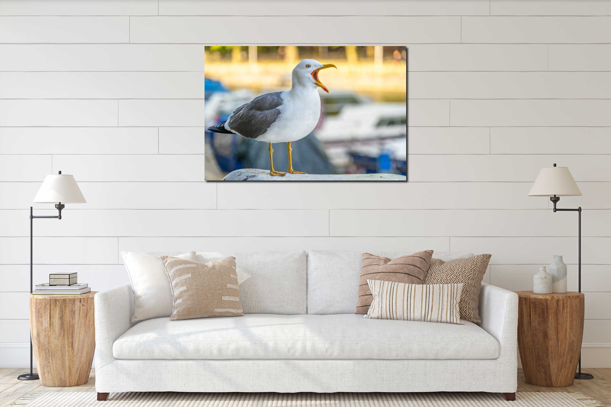 Closeup shot of a seagull standing on a concrete surface with a beak wide open interior mockup