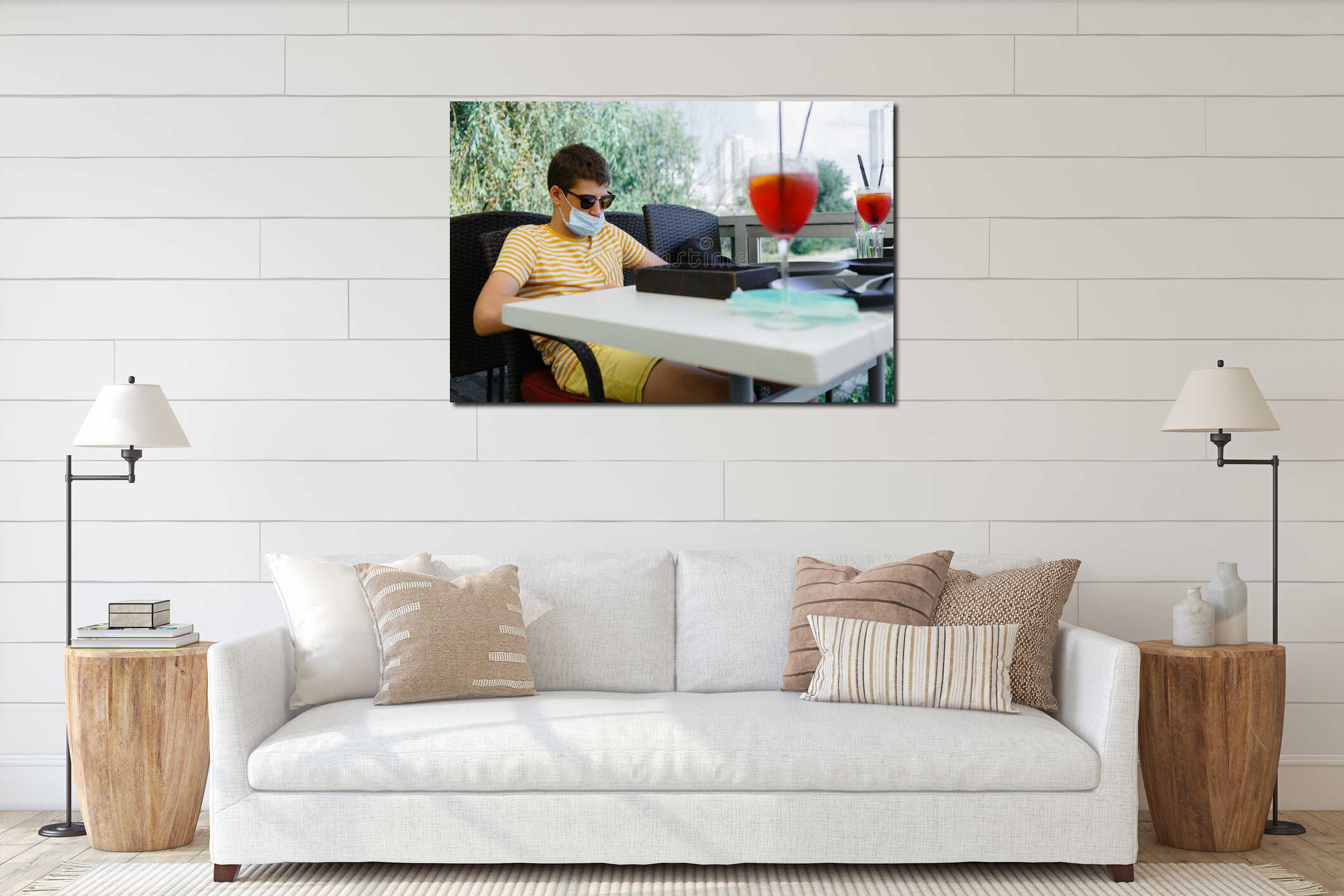 Cute teenager in yellow t shirt and mask on his face with mobile phone in hand observing in city cafe. Boy wearing protective mask interior mockup