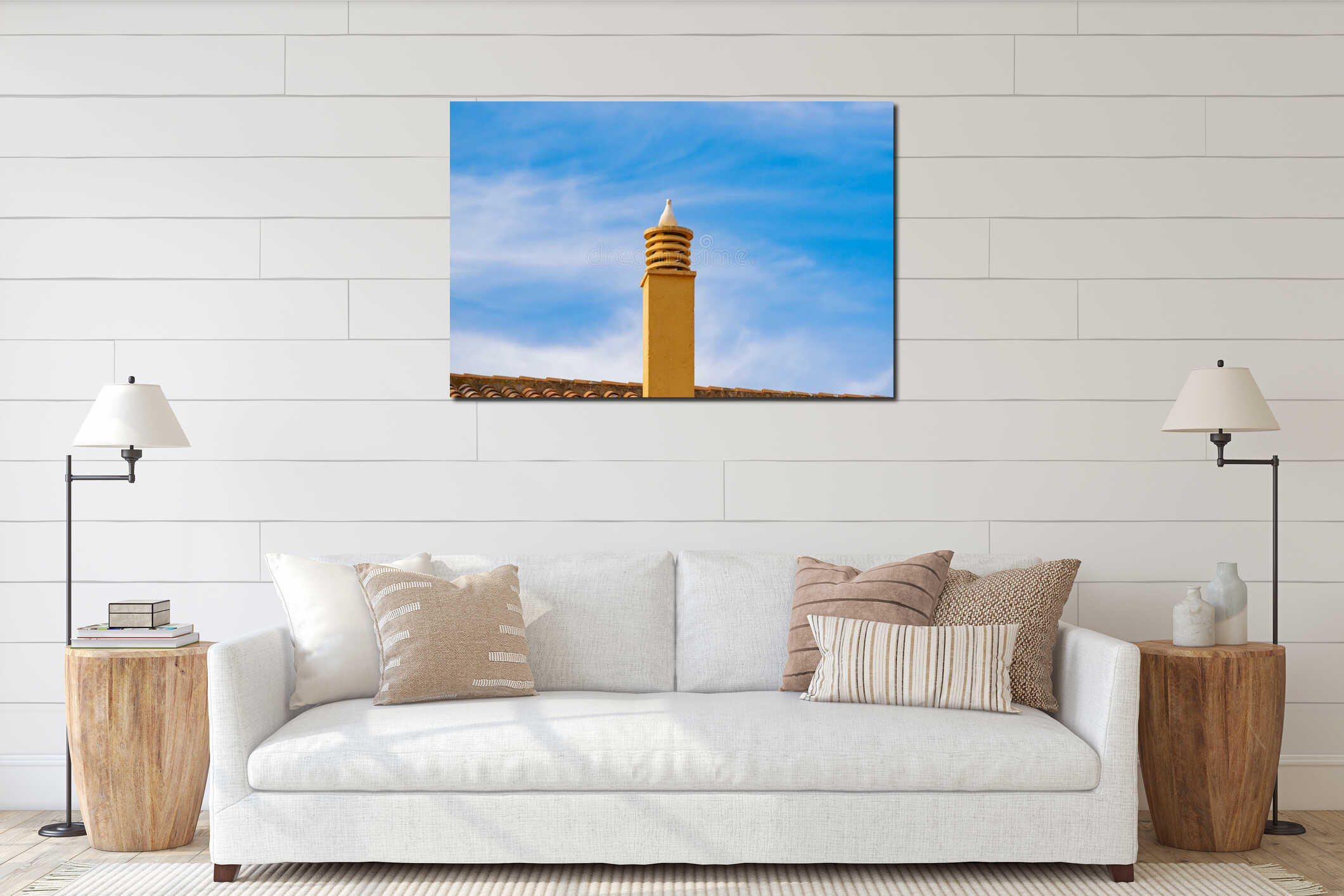 Seagull sits on a chimney on a roof against a blue sky with white clouds interior mockup