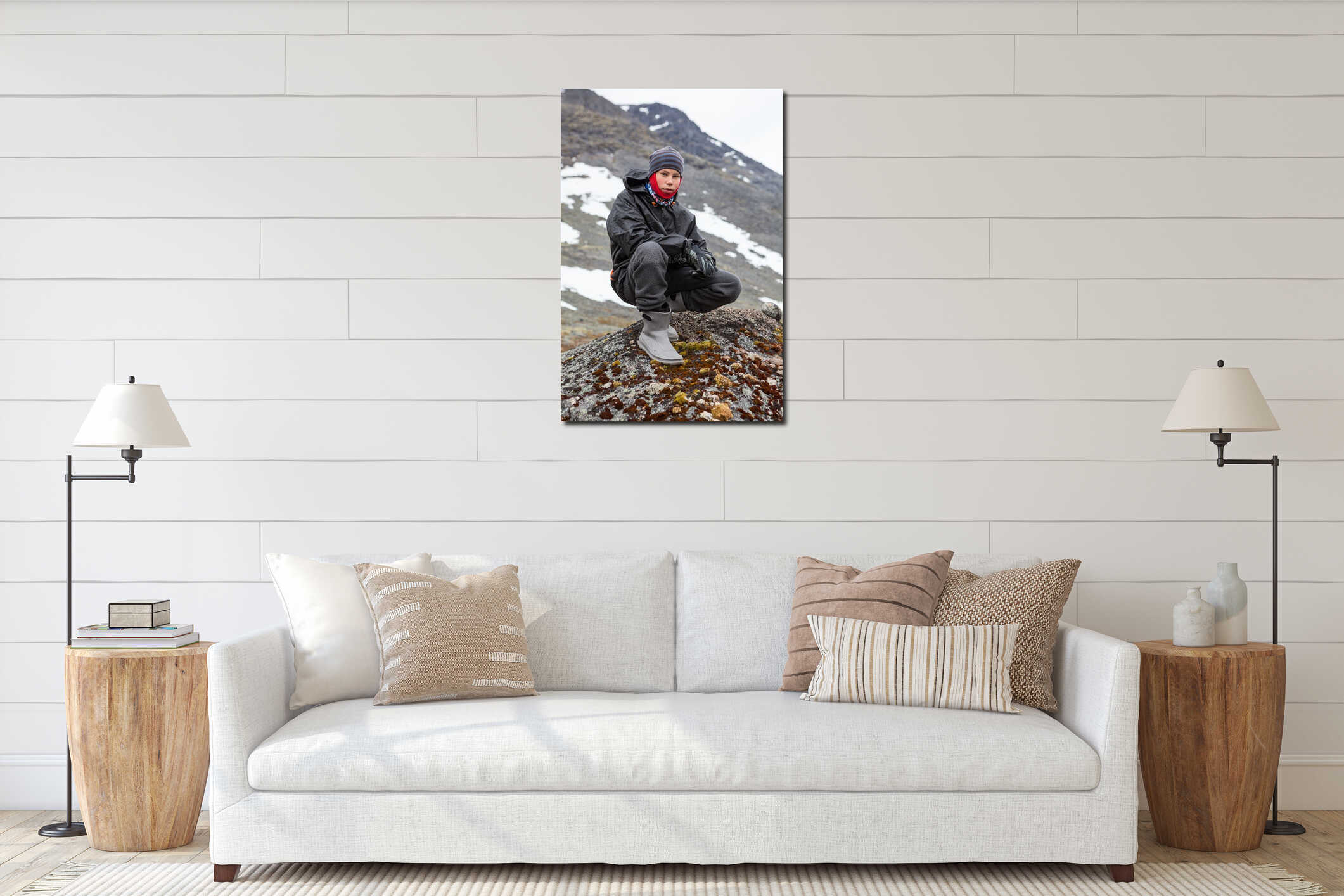 Portrait of Caucasian teenage boy dressing warm hiking outfit for mountaineering, young man sitting on big stone in mountains interior mockup