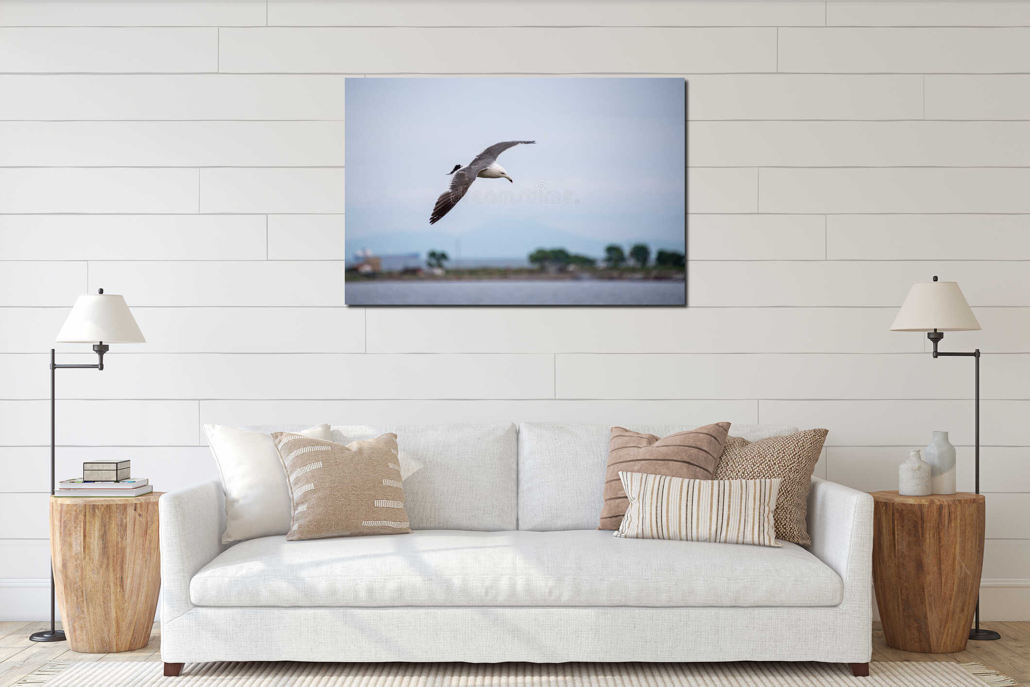 Single seagull flying in a sky as a background interior mockup