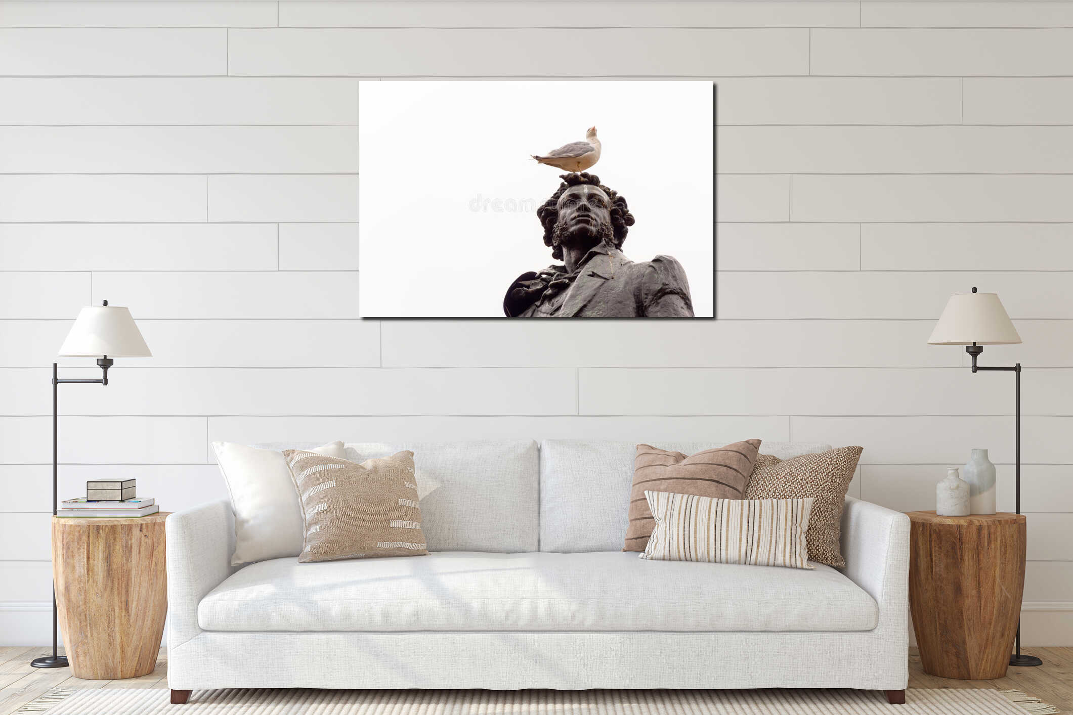 Seagull sits on the head of the monument to Alexander Pushkin on the square in front of the Russian Museum in St. Petersburg, interior mockup