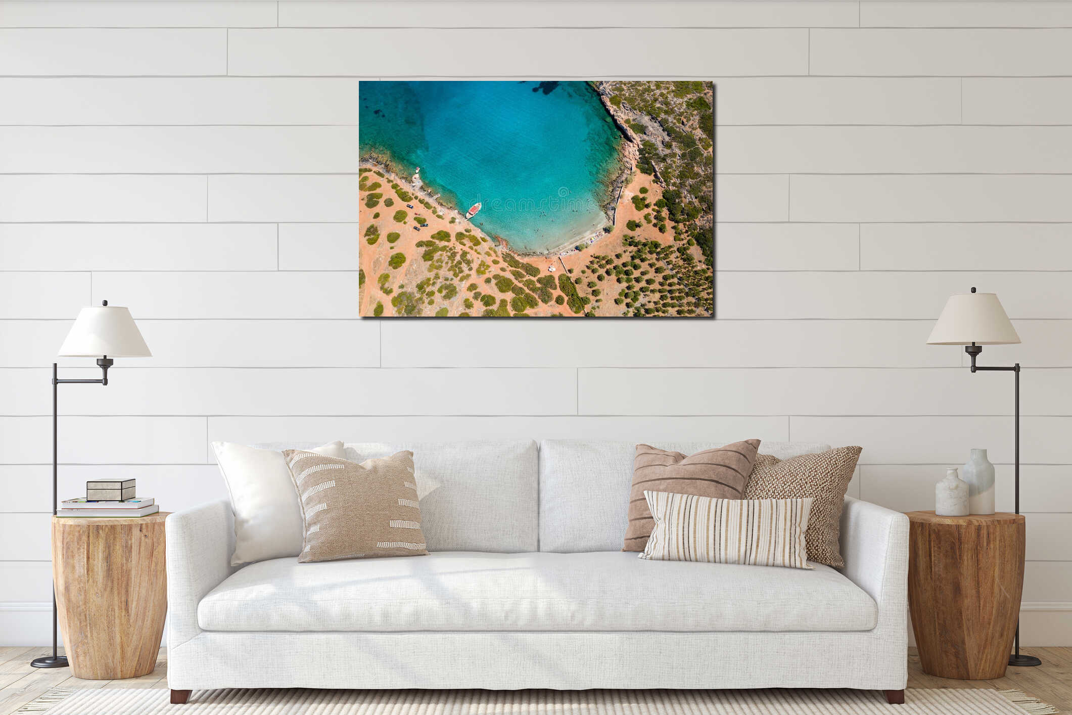 Aerial drone view of a small beach on a rocky, barren coastline and crystal clear ocean interior mockup