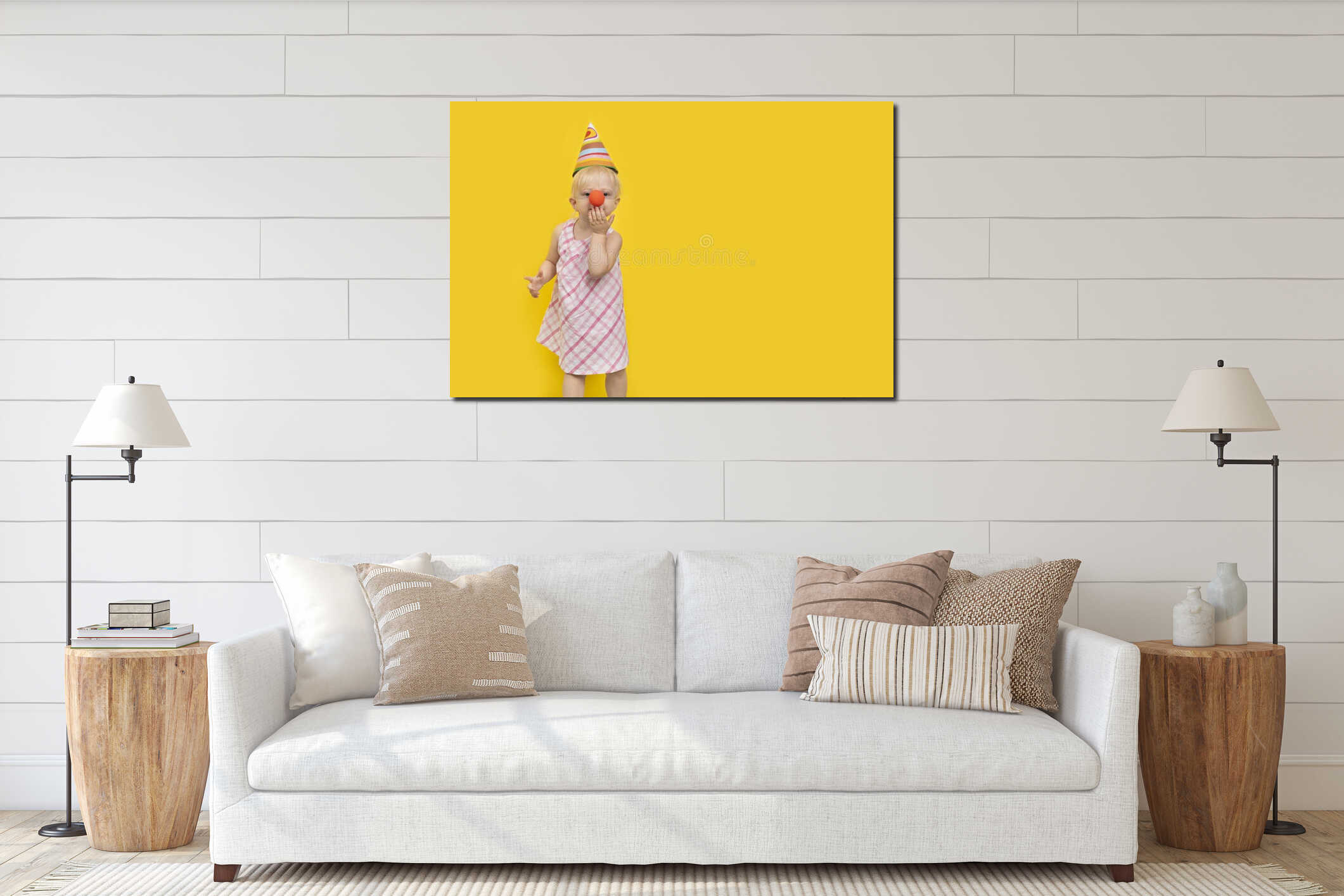 Girl dressed as clown with party hat sends kiss. Colorful Studio portrait with yellow background. Copy space interior mockup