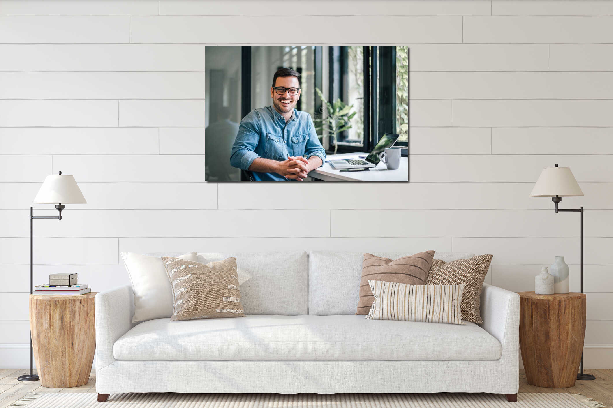 Portrait of young smiling happy handsome successful businessman entrepreneur freelancer working from home office on laptop interior mockup