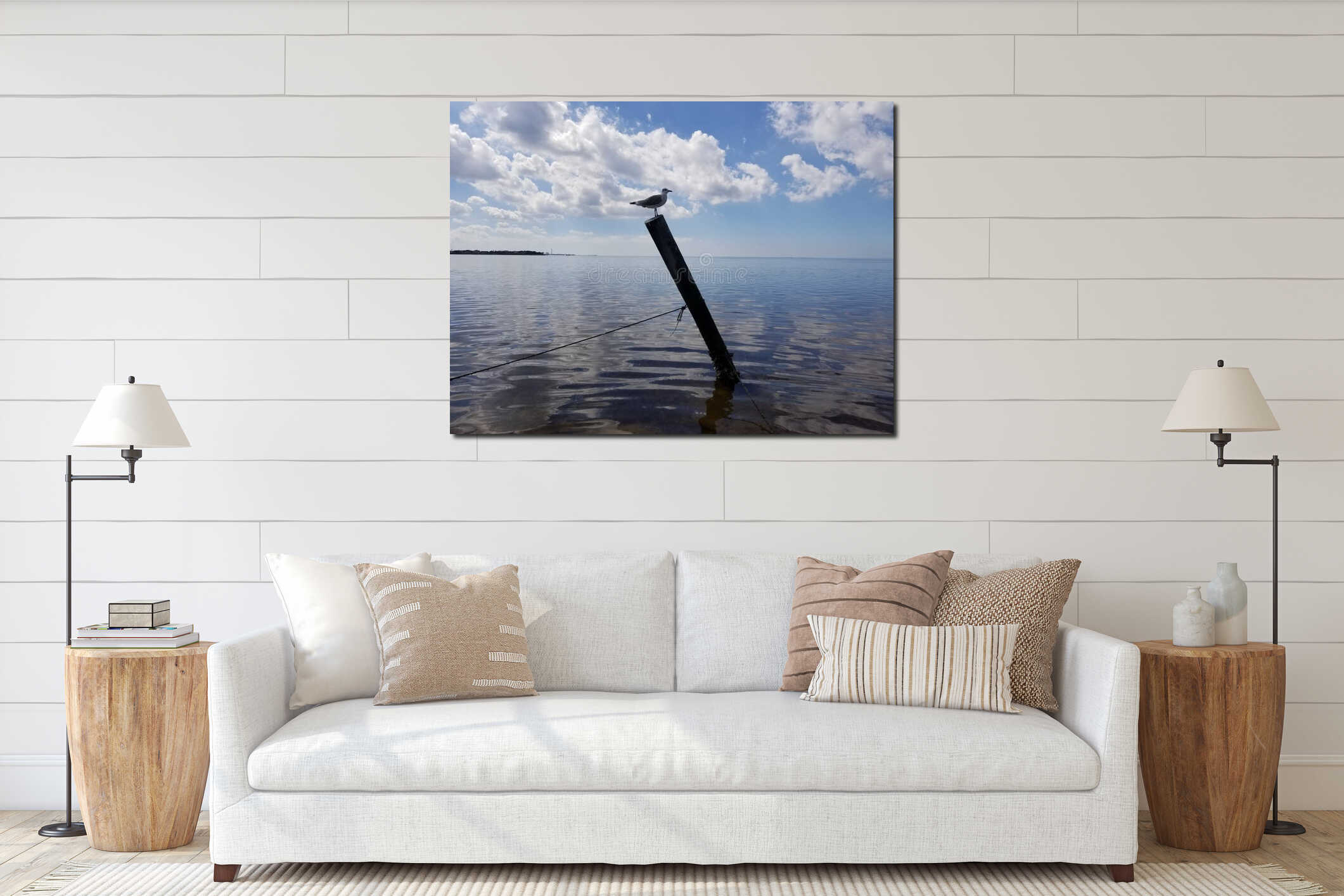 Seagull perched on a wooden pole in the ocean interior mockup