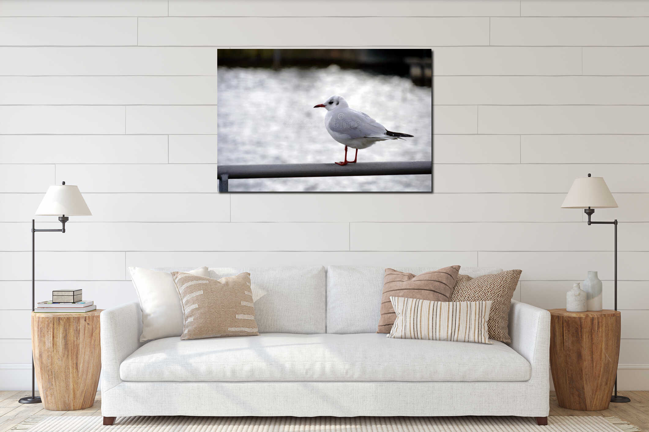 A seagull in lateral view standing on the top of metal railing on the pier or in harbor with Lake Zurich in Switzerland behind it. interior mockup