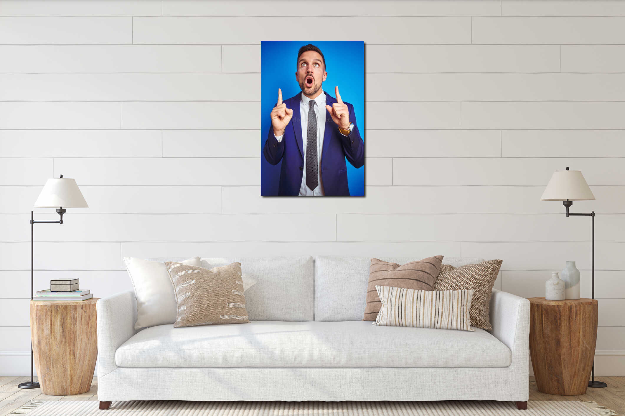 Vertical angle picture of young handsome business man over blue  background amazed and surprised looking up and pointing interior mockup