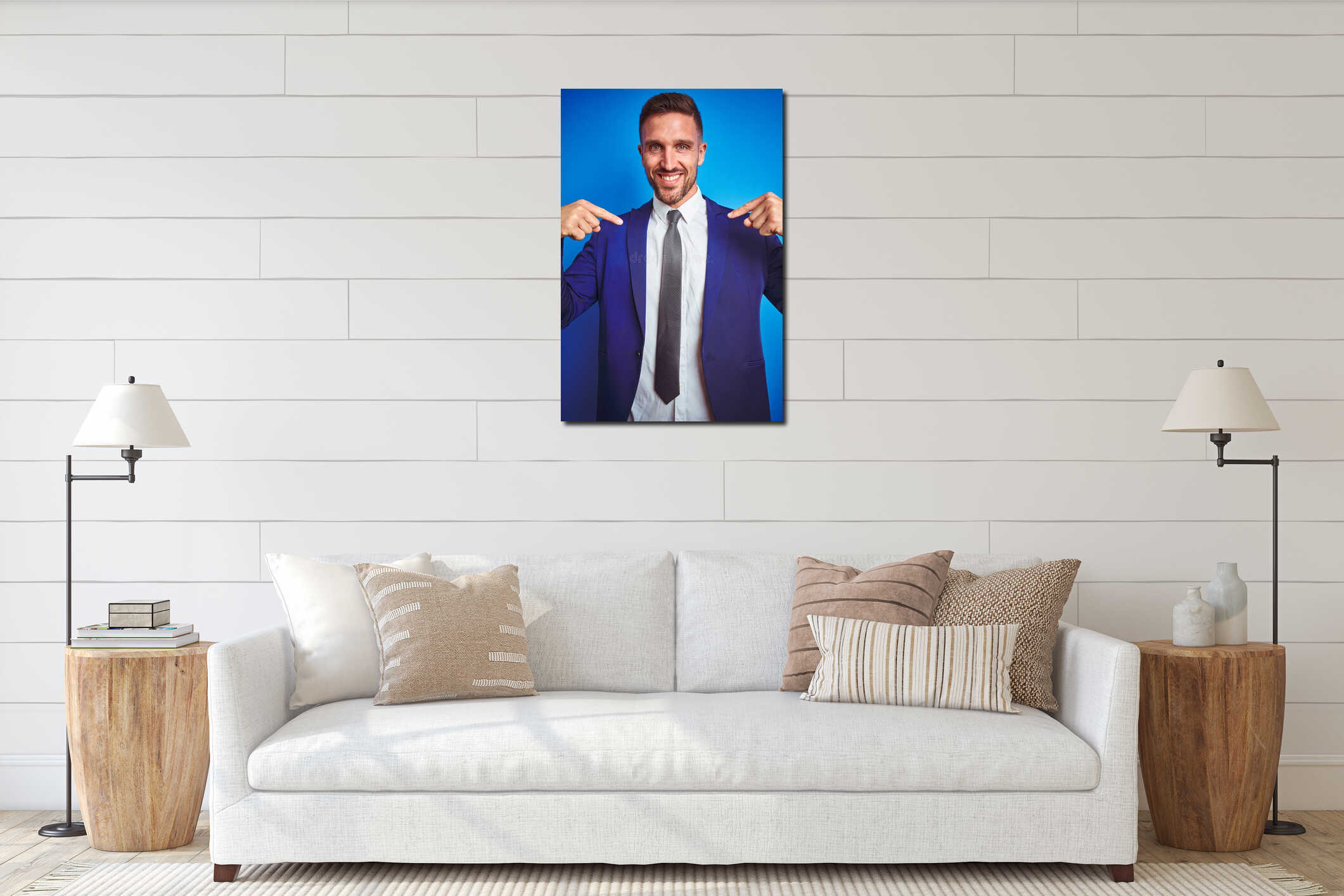 Vertical angle picture of young handsome business man over blue  background looking confident with smile on face, pointing interior mockup