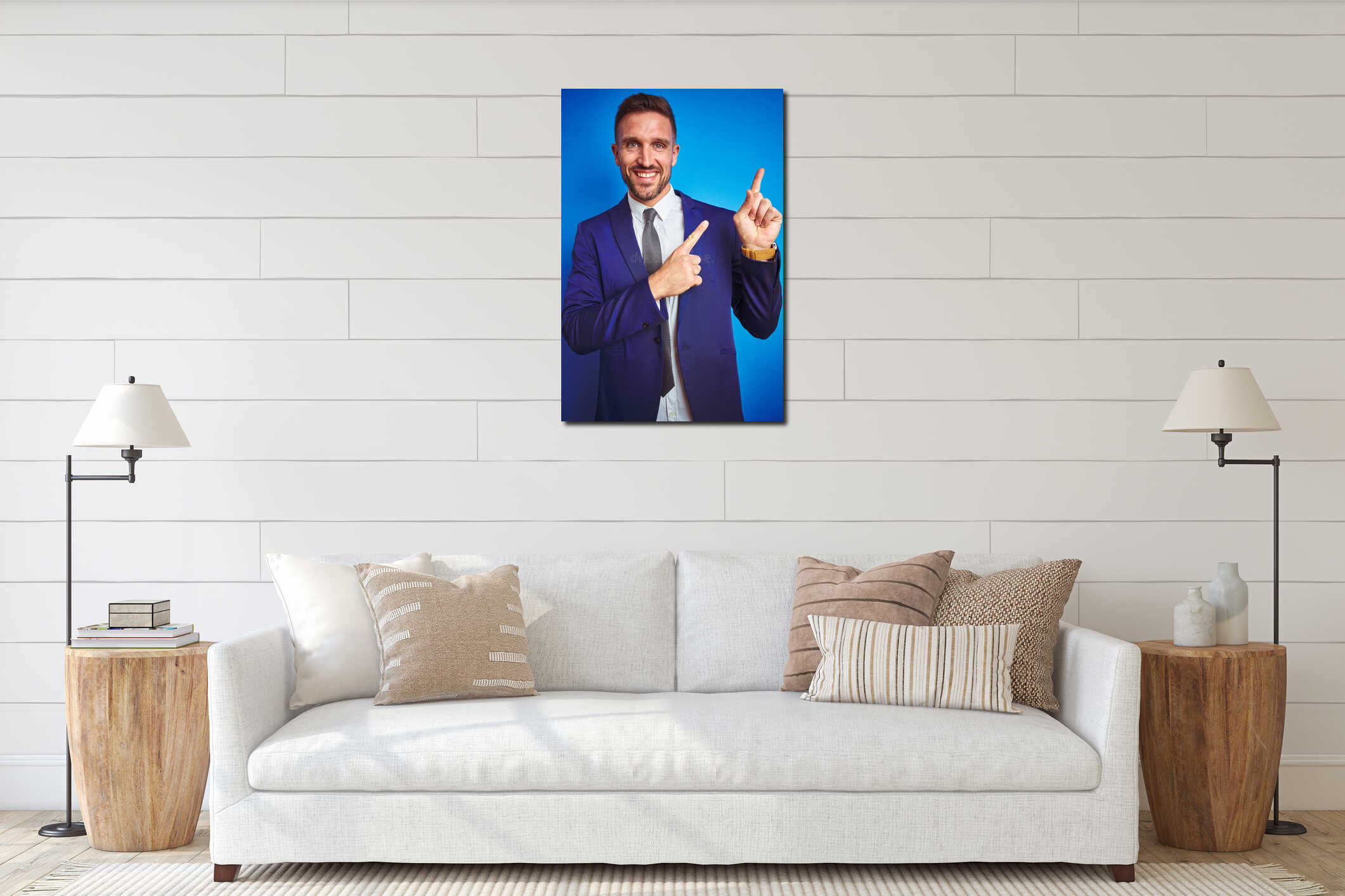 Vertical angle picture of young handsome business man over blue isolated background smiling and looking at the camera pointing interior mockup