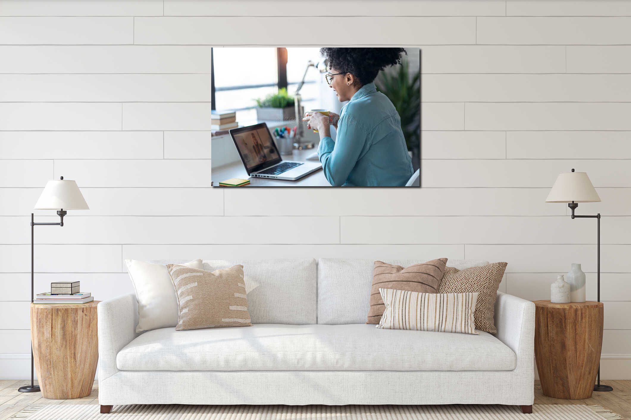 Beautiful young afro business woman making video call with laptop while drinking coffee sitting in the office at home interior mockup