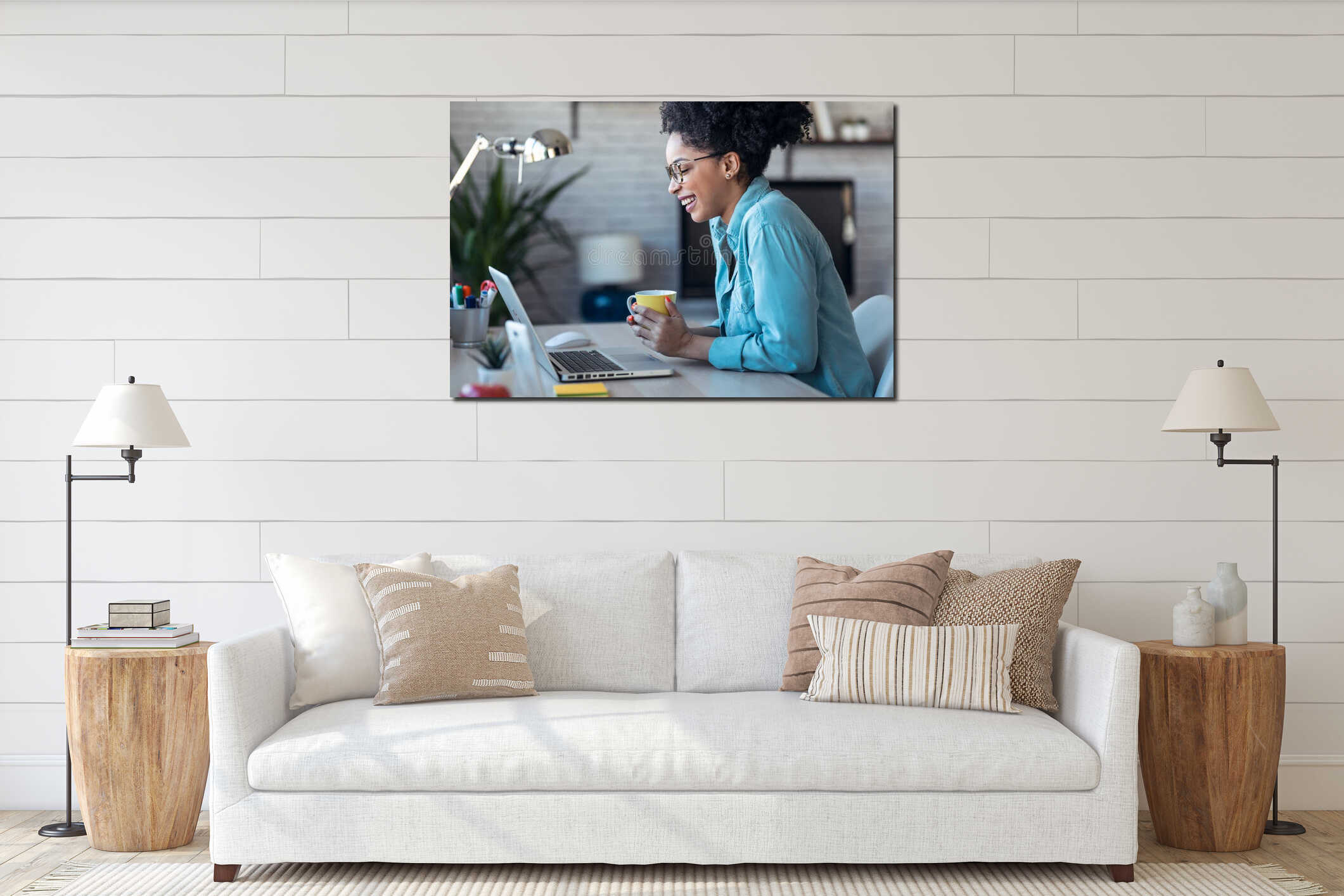 Beautiful young afro business woman making video call with laptop while drinking coffee sitting in the office at home interior mockup