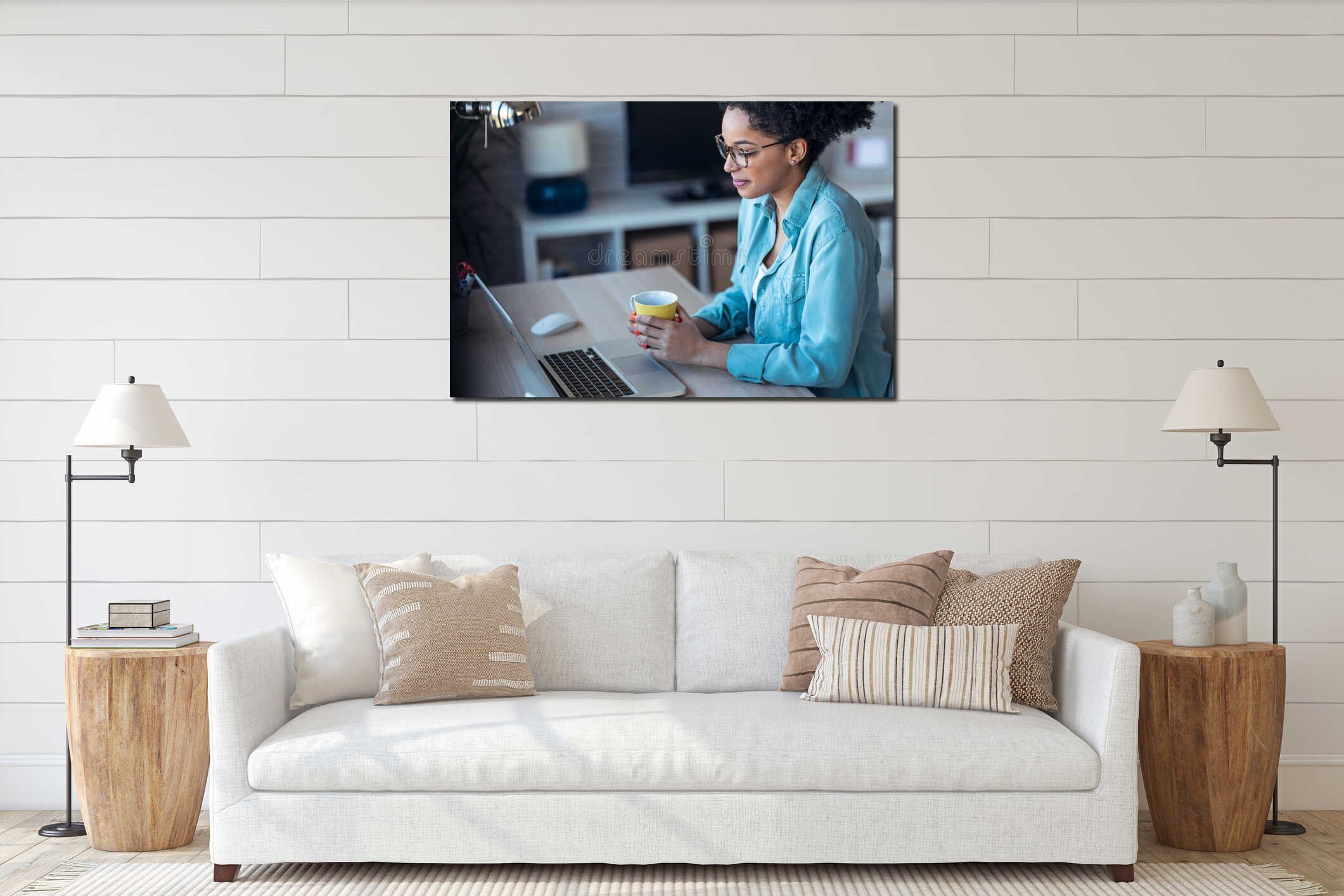 Beautiful young afro business woman making video call with laptop while drinking coffee sitting in the office at home interior mockup