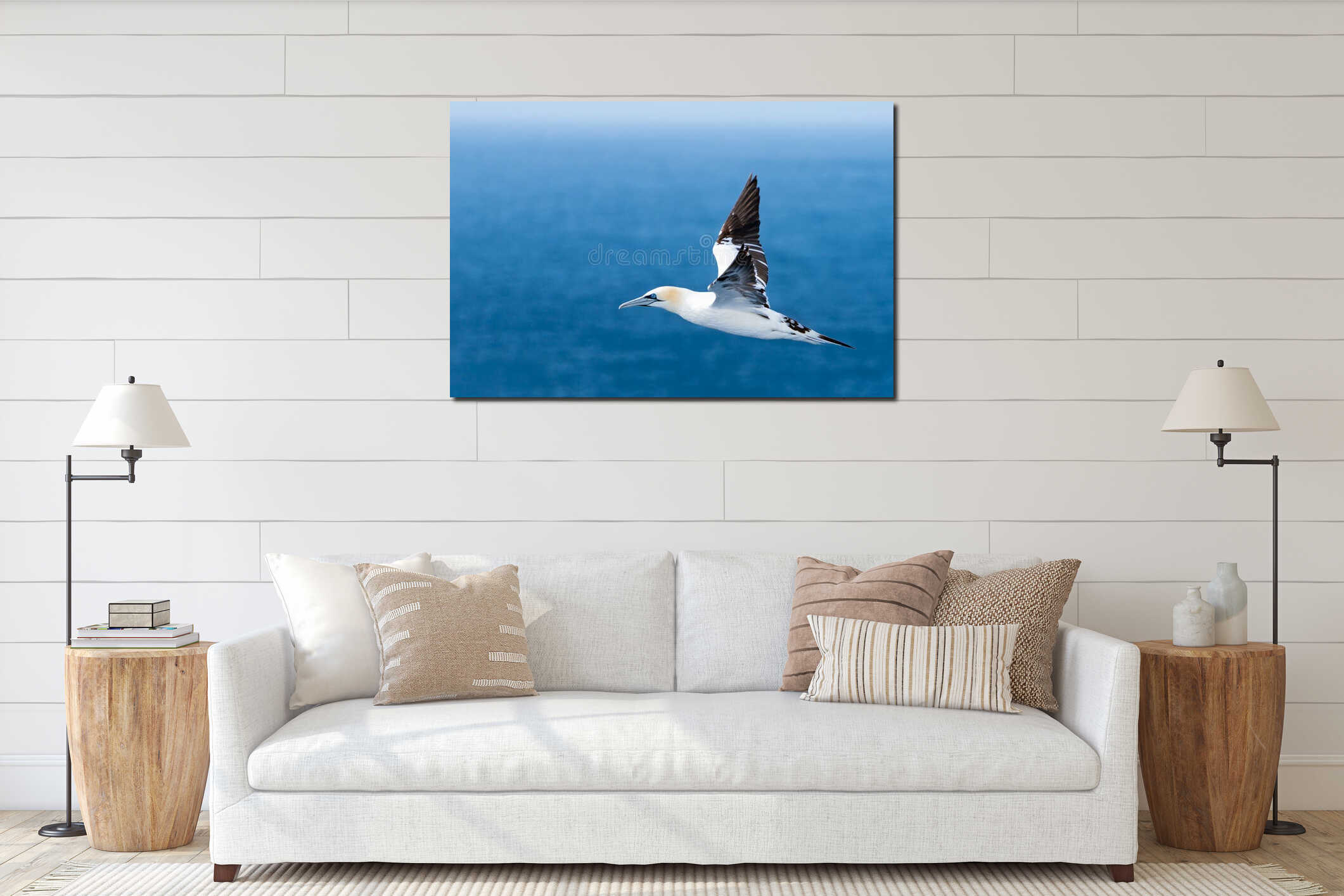 Northern gannet flies above blue waters of the North Atlantic ocean near Iceland. Elegant Morus bassanus travels through the interior mockup