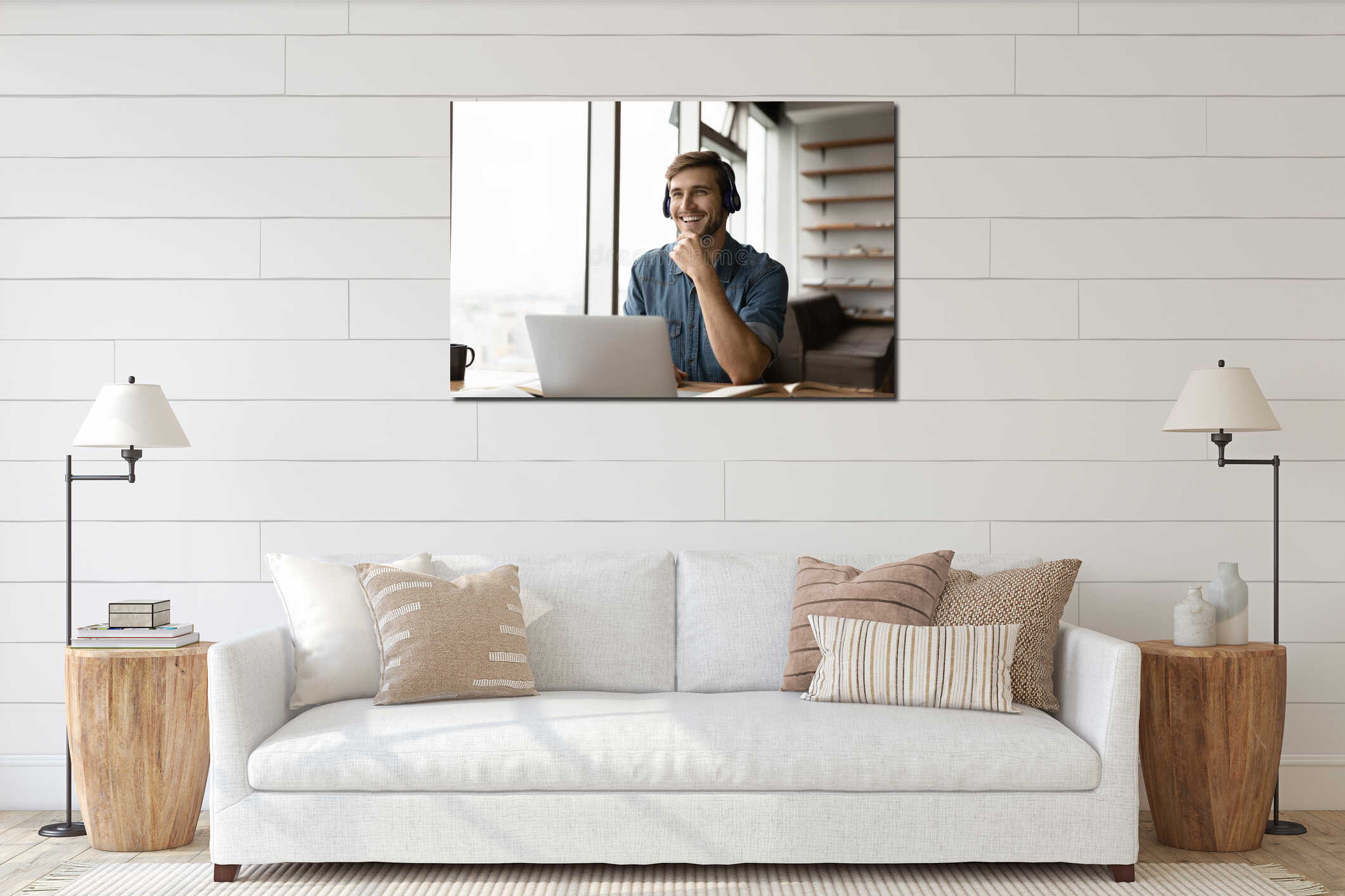 Smiling young man in earphones have fun working on laptop interior mockup