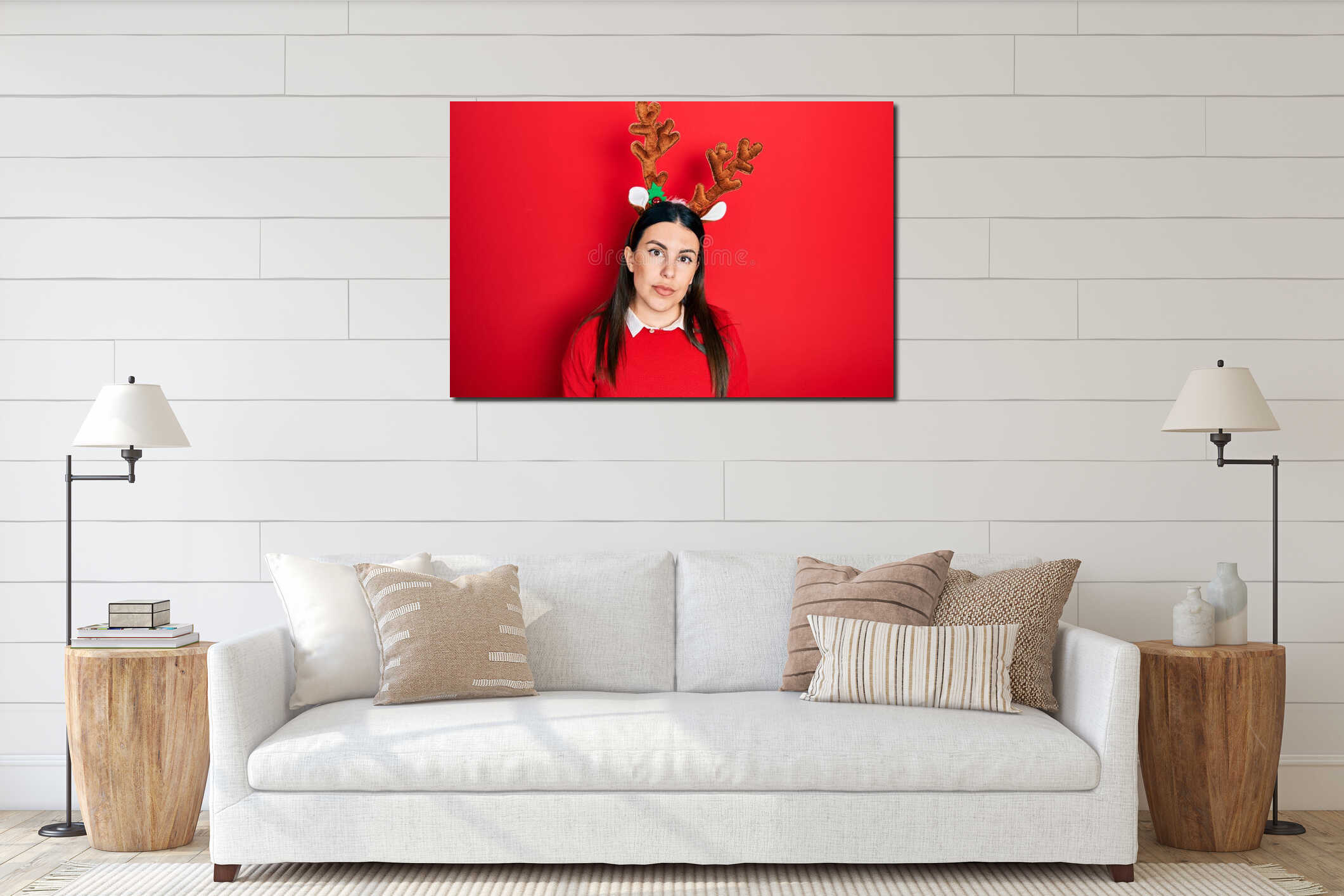 Young hispanic woman wearing cute christmas reindeer horns with serious expression on face interior mockup