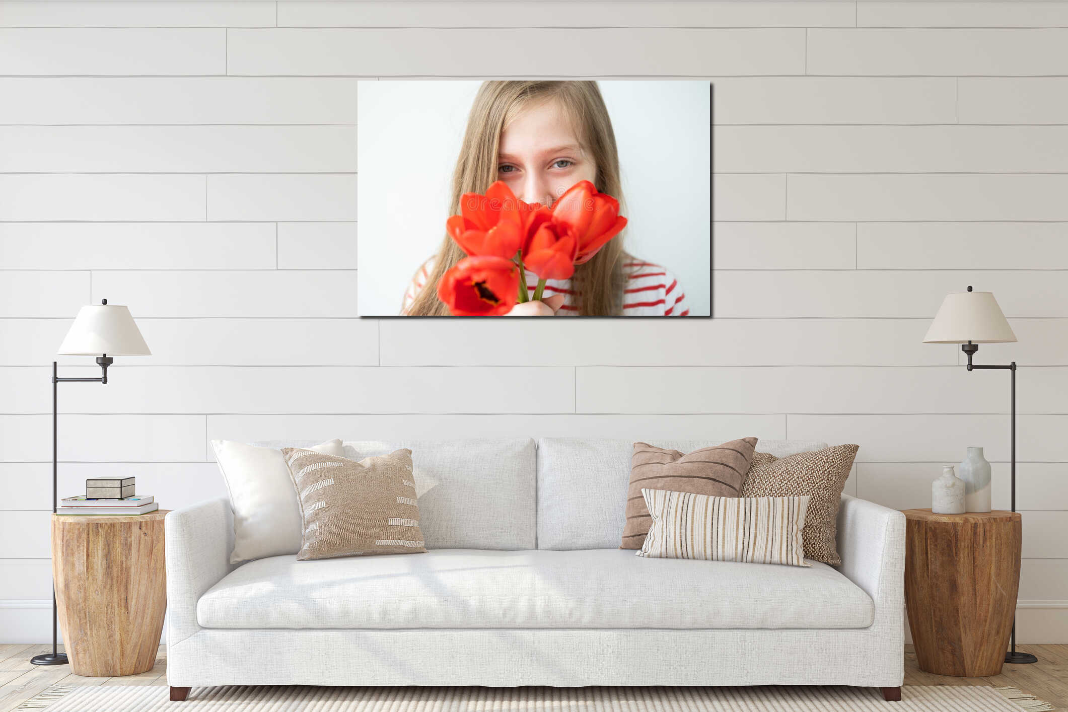 portrait happy teenage girl with long hair with red tulips standing against white wall interior mockup