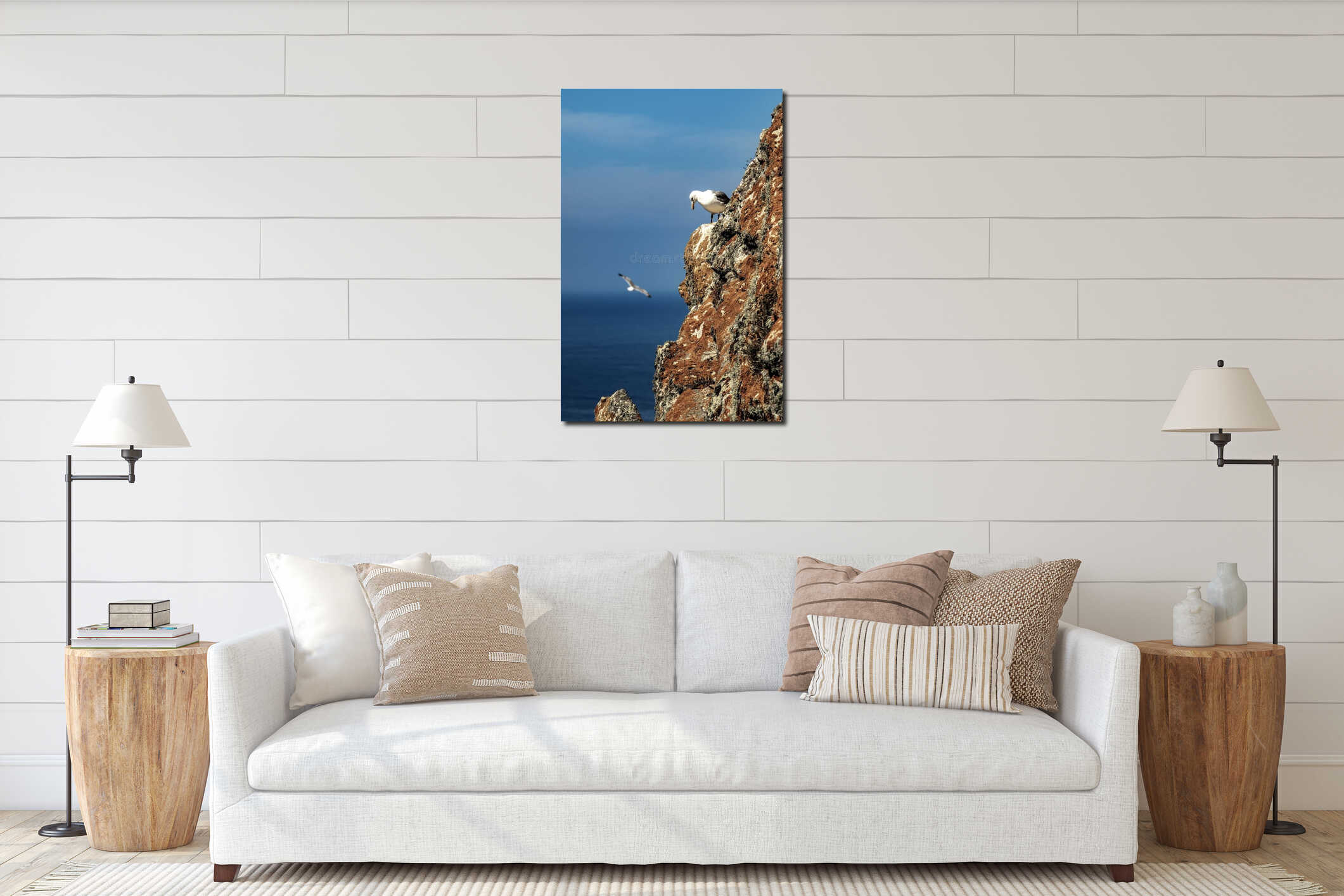 Seagull looking down on a rocky cliff covered in moss interior mockup