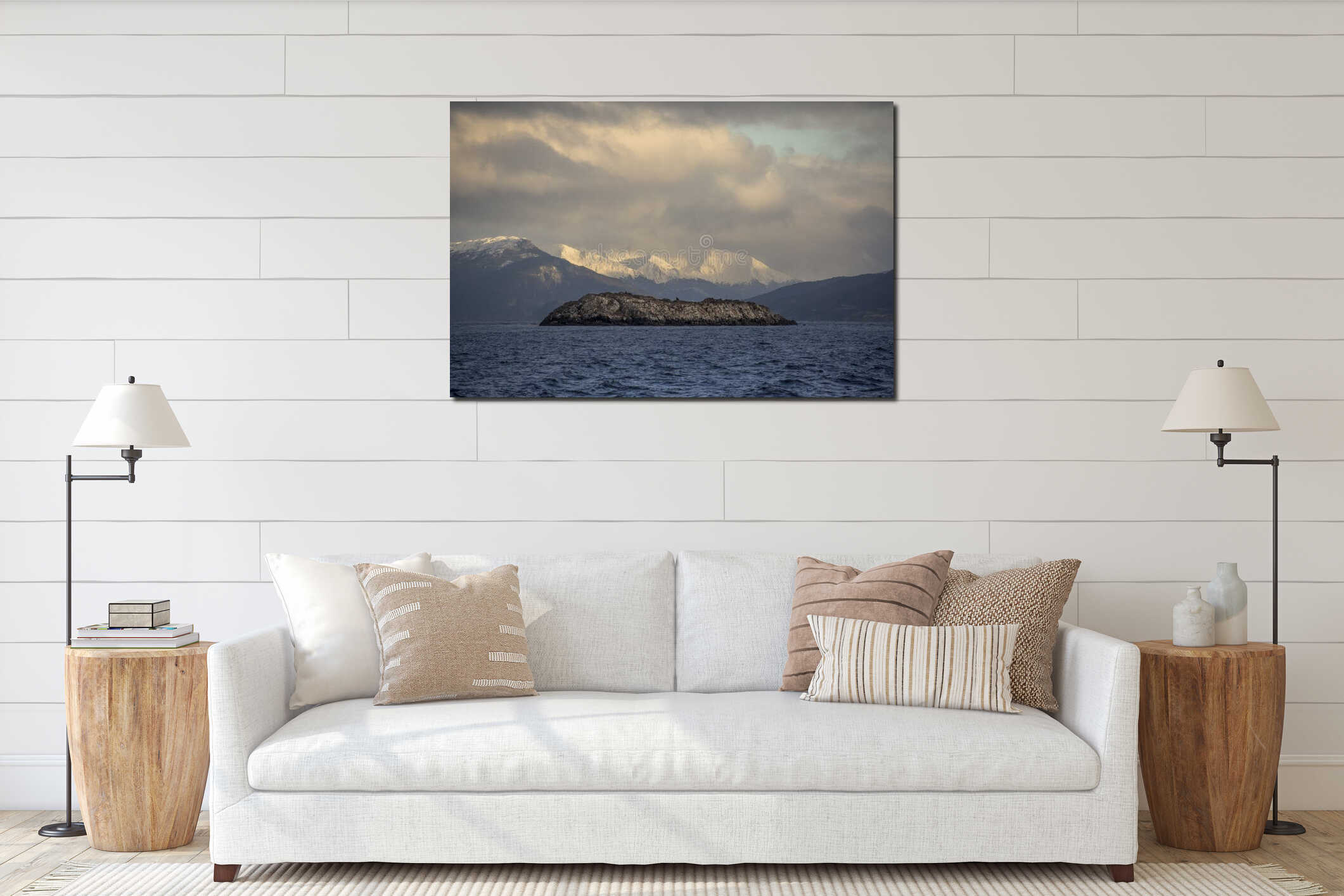 Centered photo of a little desertic island with sea animals and snowed Andes mountains with sunlight in the background interior mockup