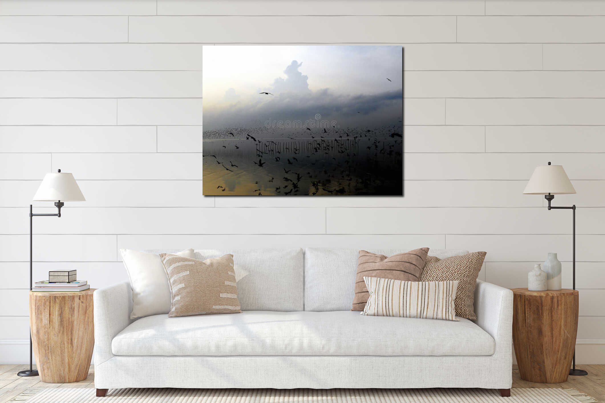 Silhouette of seagull with gray cloud and golden sea at sunrise interior mockup