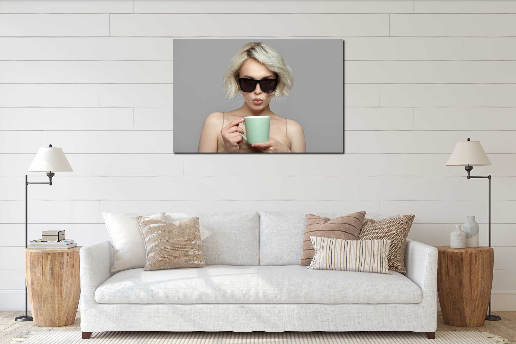 Portrait of a blonde girl with a short haircut in sunglasses holds a cup of coffee in her hands. interior mockup