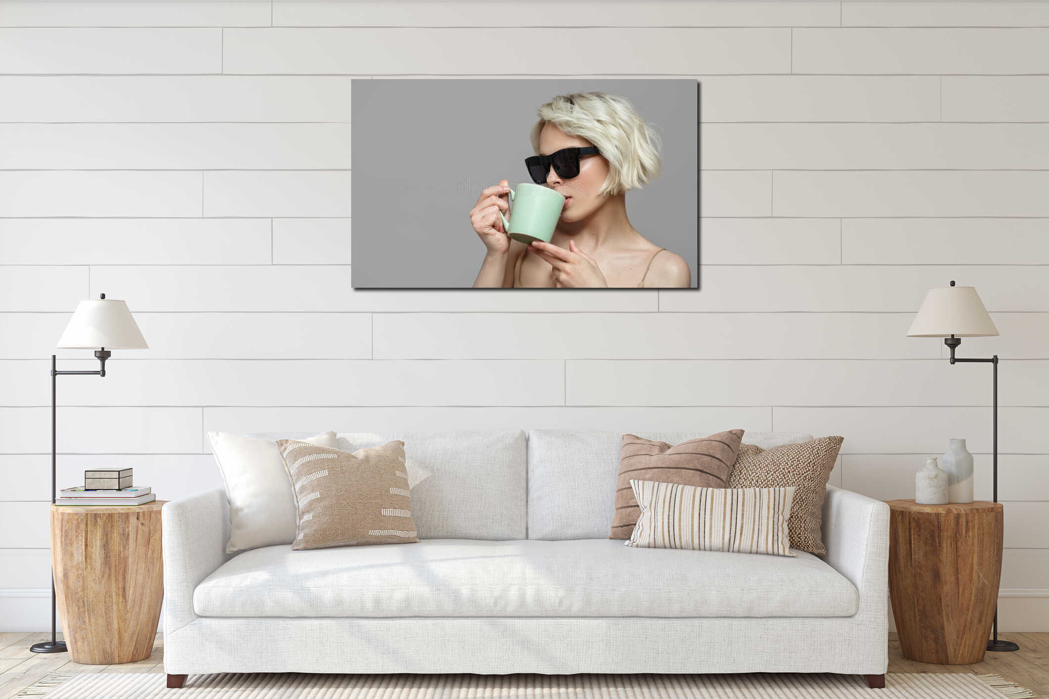 Portrait of a blonde girl with a short haircut in sunglasses holds a cup of coffee in her hands. interior mockup