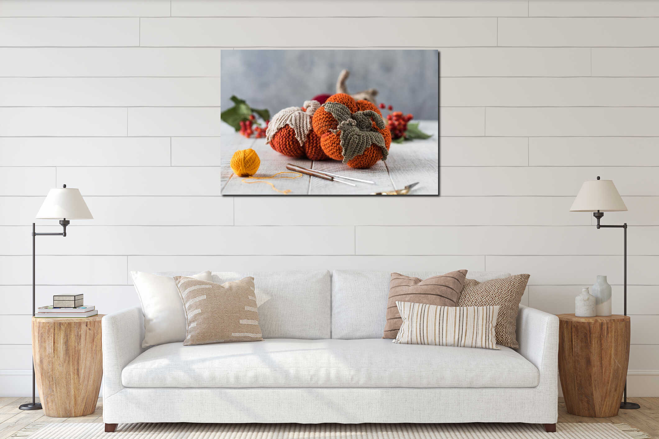 Knitted pumpkins with leaves crochets and scissors on table interior mockup