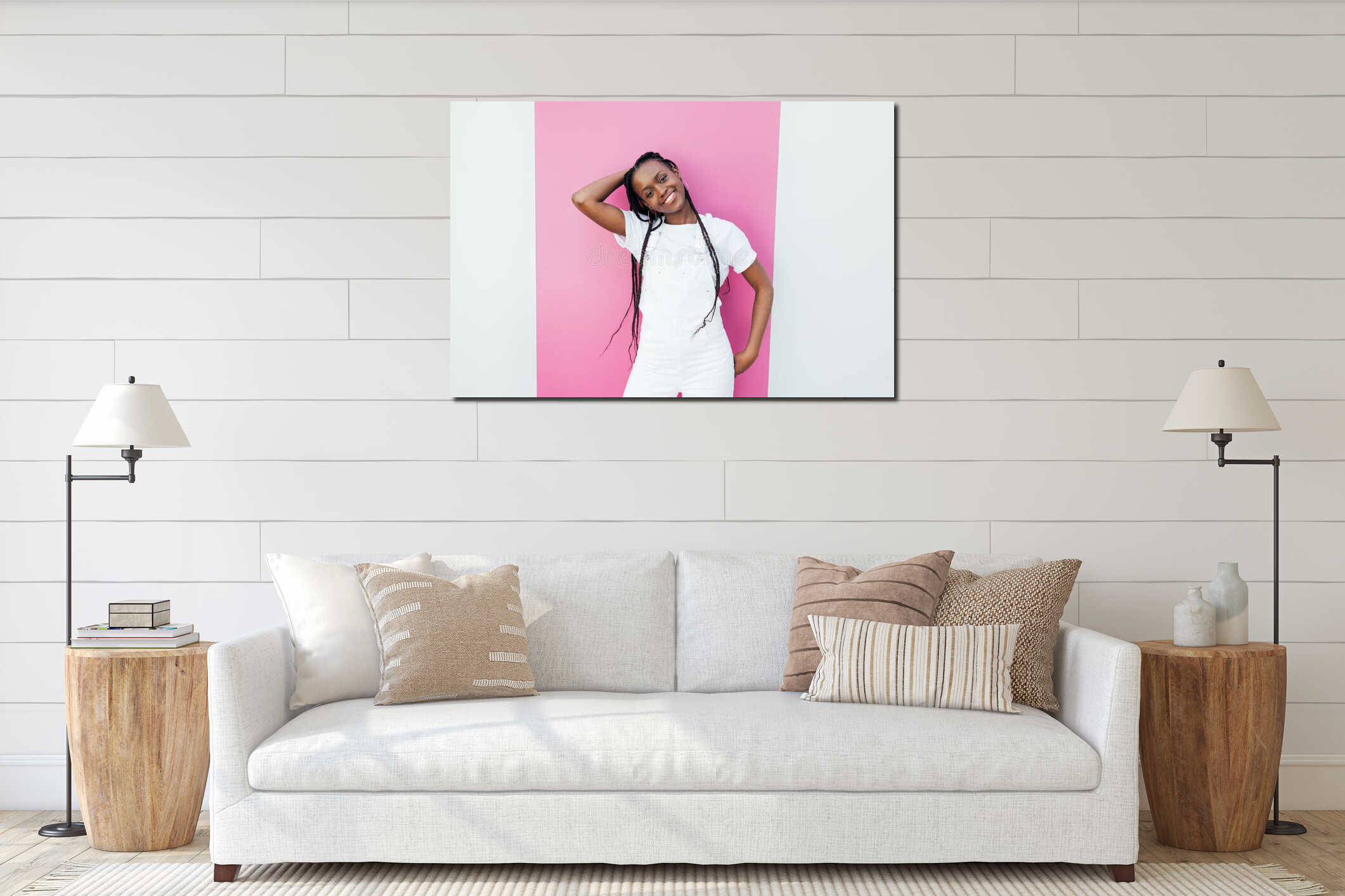 Portrait of a young cheerful girl wearing a white overall standing at wall with pink stripe interior mockup