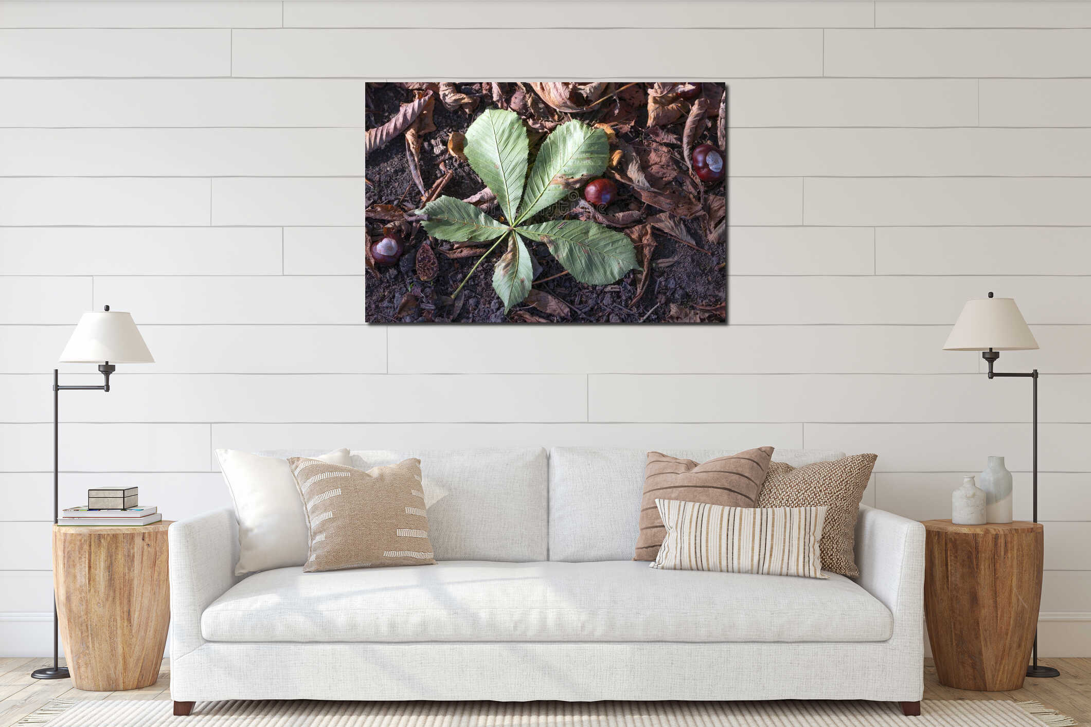 A large green chestnut leaf and chestnuts lie on the ground. interior mockup