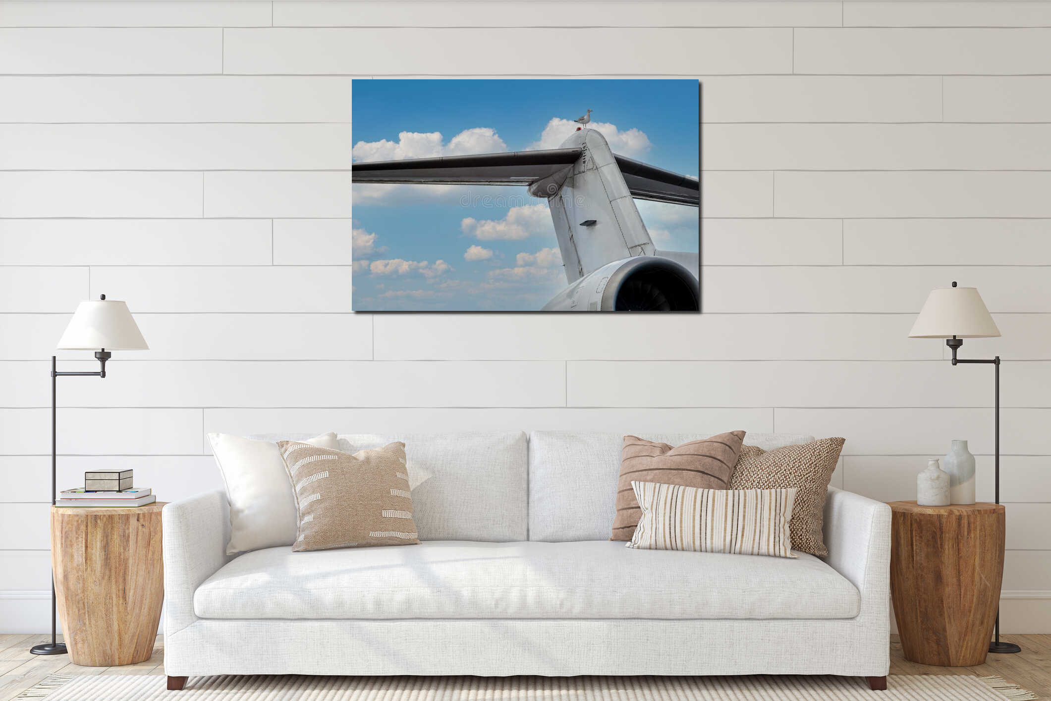 A seagull sits on the wing of an airplane against the backdrop of a blue cloudy sky interior mockup