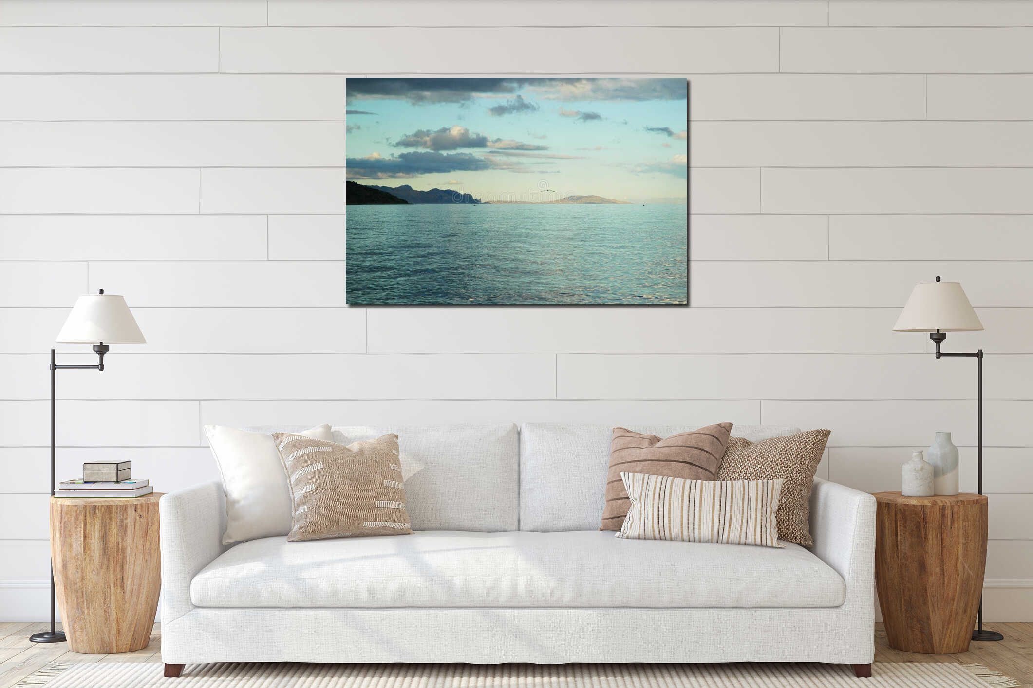 Seascape at sunset. Mountainous terrain. A seagull is flying over the sea. interior mockup