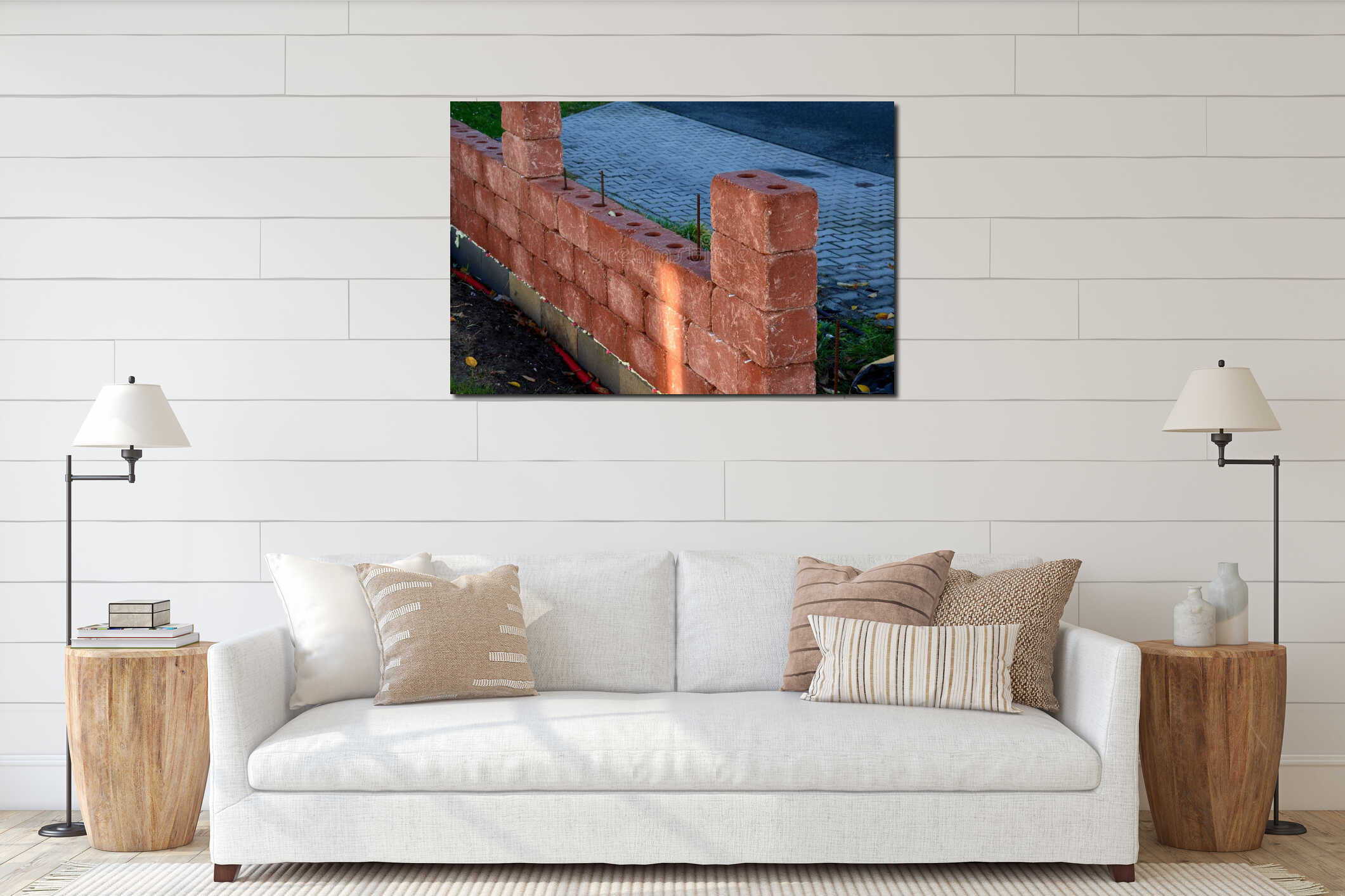 Construction of fencing from concrete fittings. inside the red bricks are holes for inserting reinforcing steel wires and filling interior mockup