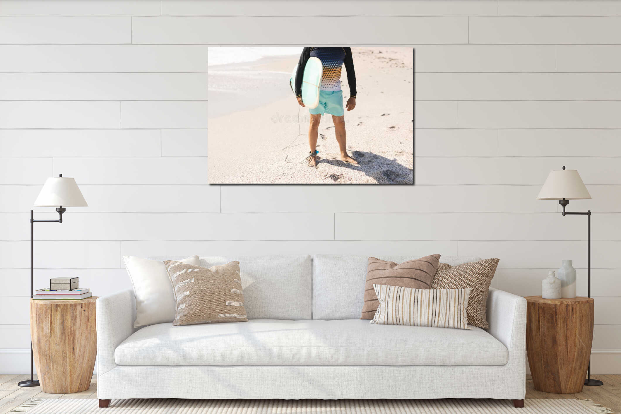 Low section of biracial senior man holding surfboard standing on shore at sunny beach interior mockup