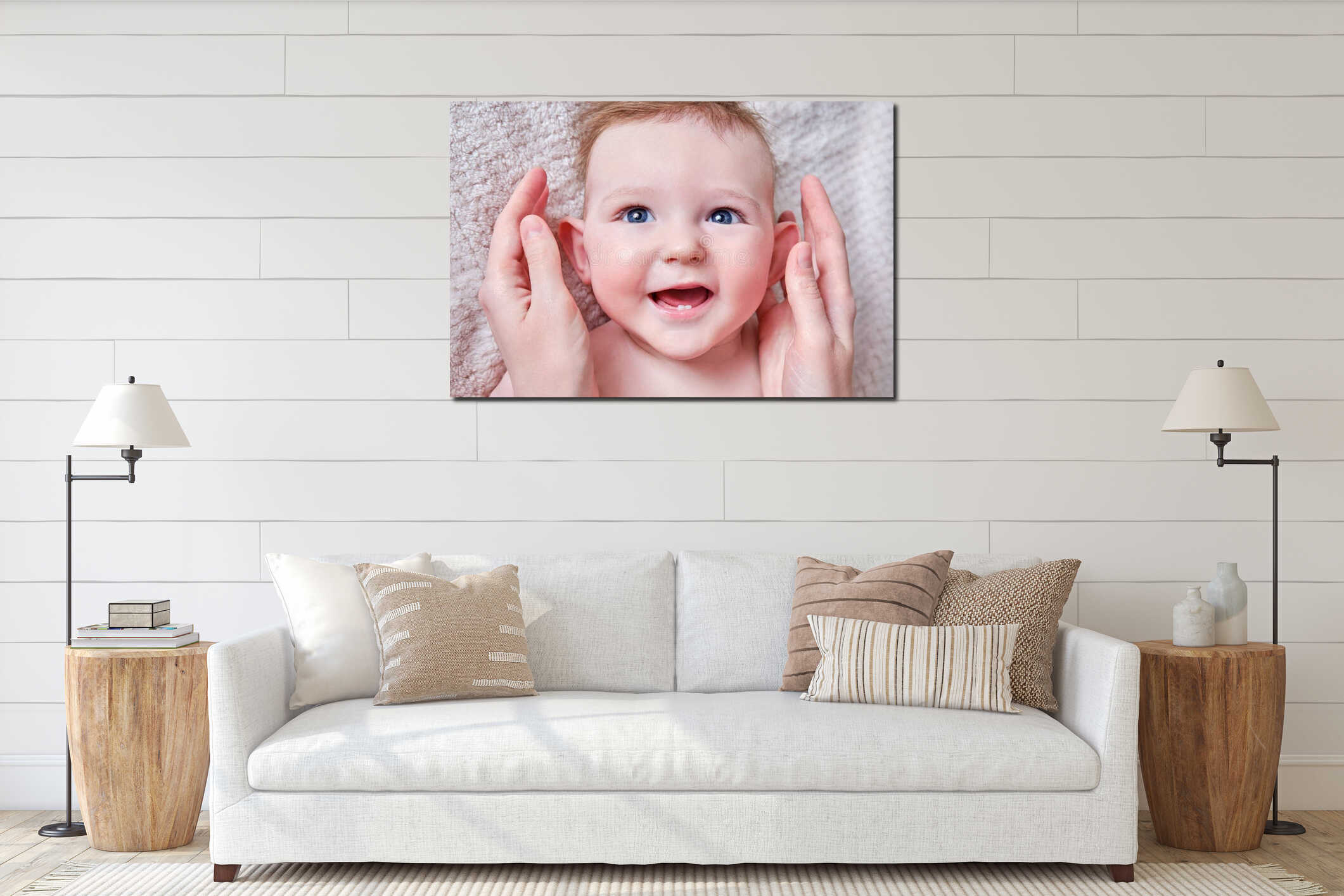 Portrait of a happy infant baby and mom hand. Mother stroking the face of a smiling toddler child on a sofa, six to seven months interior mockup