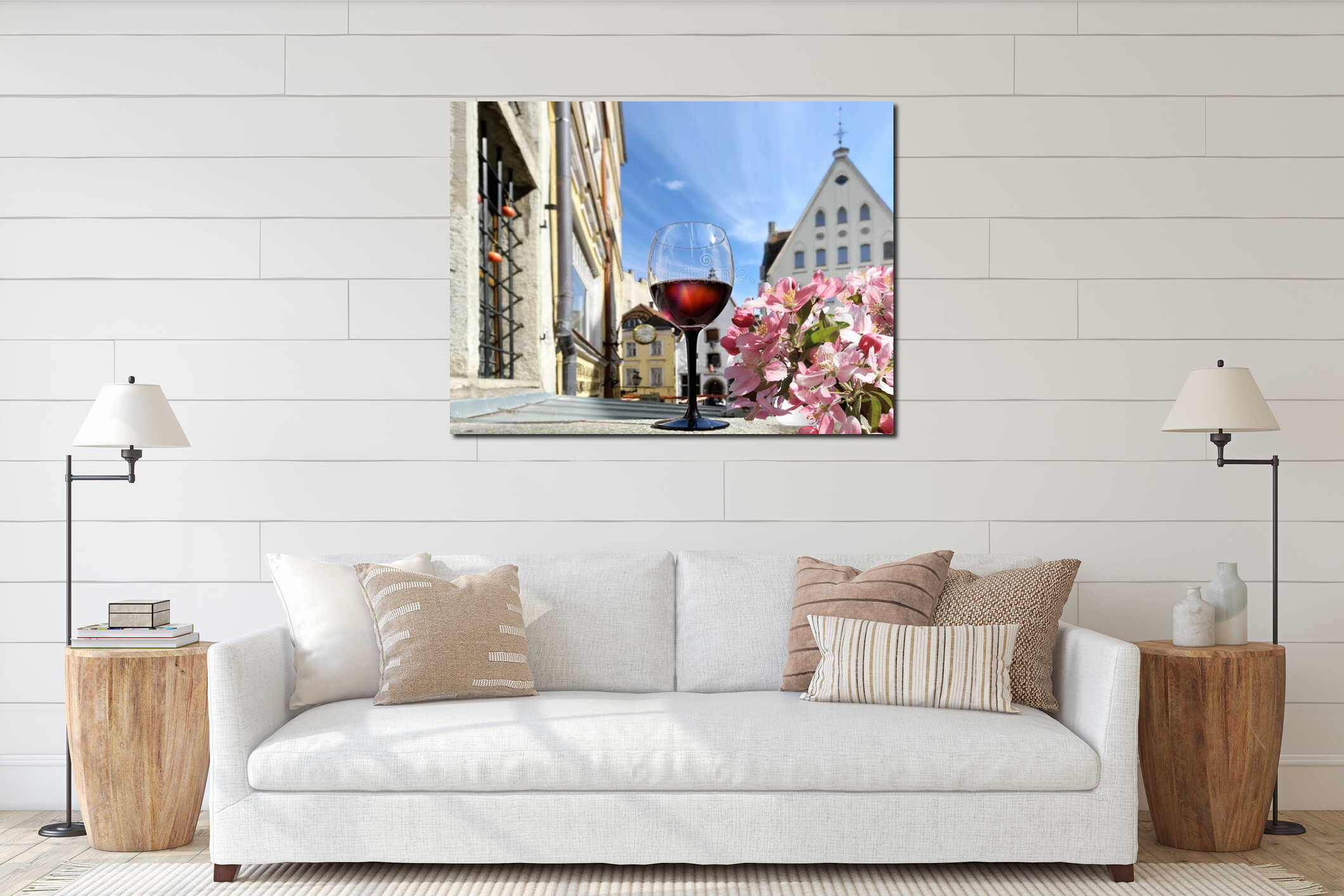 Pink flowers and glass of red wine on top in summer spring Tallinn old town medieval houses in Estonia interior mockup