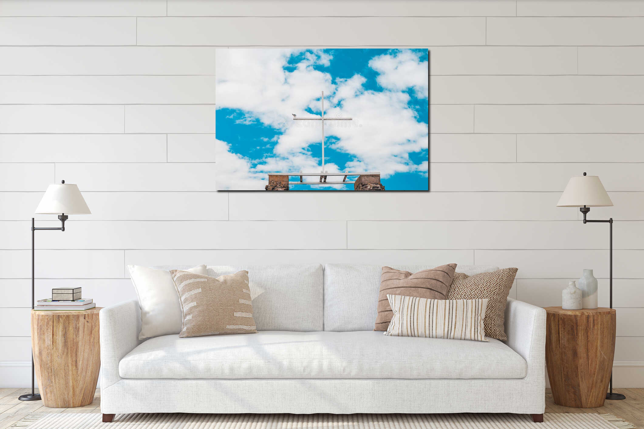 A white wooden cross against a blue sky with clouds, a seagull sits on the edge interior mockup